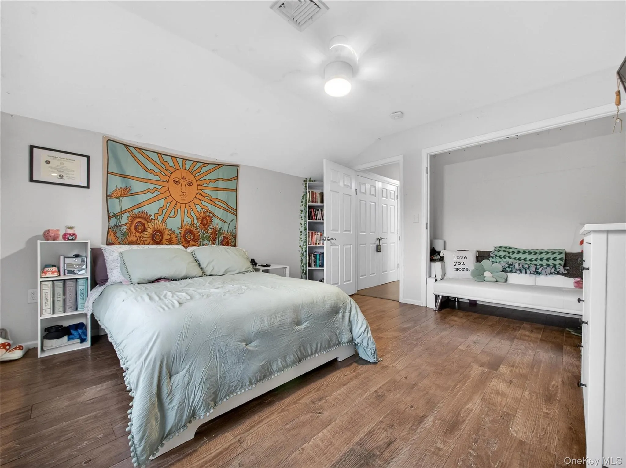 Bedroom featuring lofted ceiling and hardwood / wood-style floors Bedroom featuring lofted ceiling and hardwood / wood-style floors