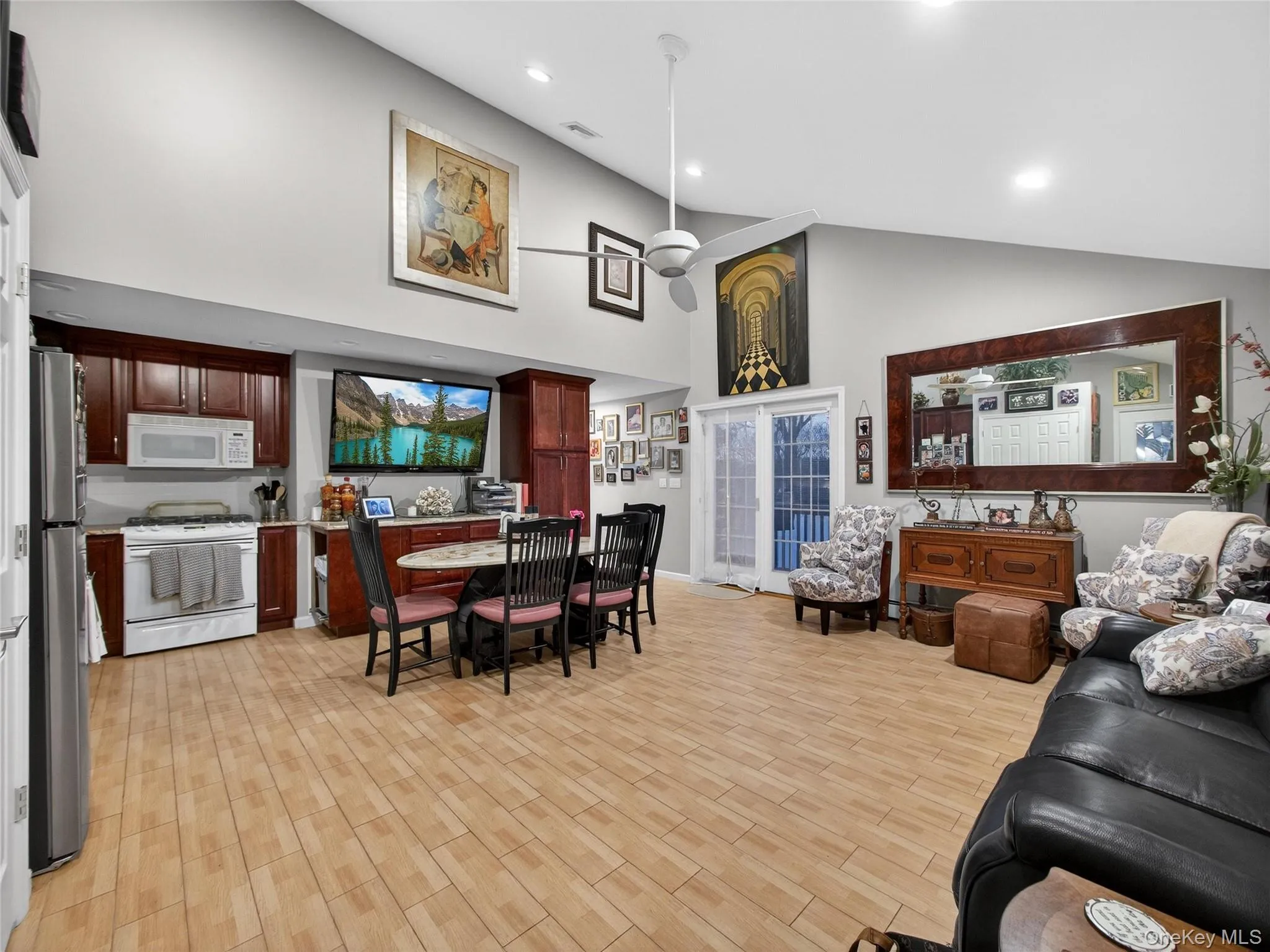 Living area with wood tiled floors, high vaulted ceiling, and recessed lighting Living area with wood tiled floors, high vaulted ceiling, and recessed lighting