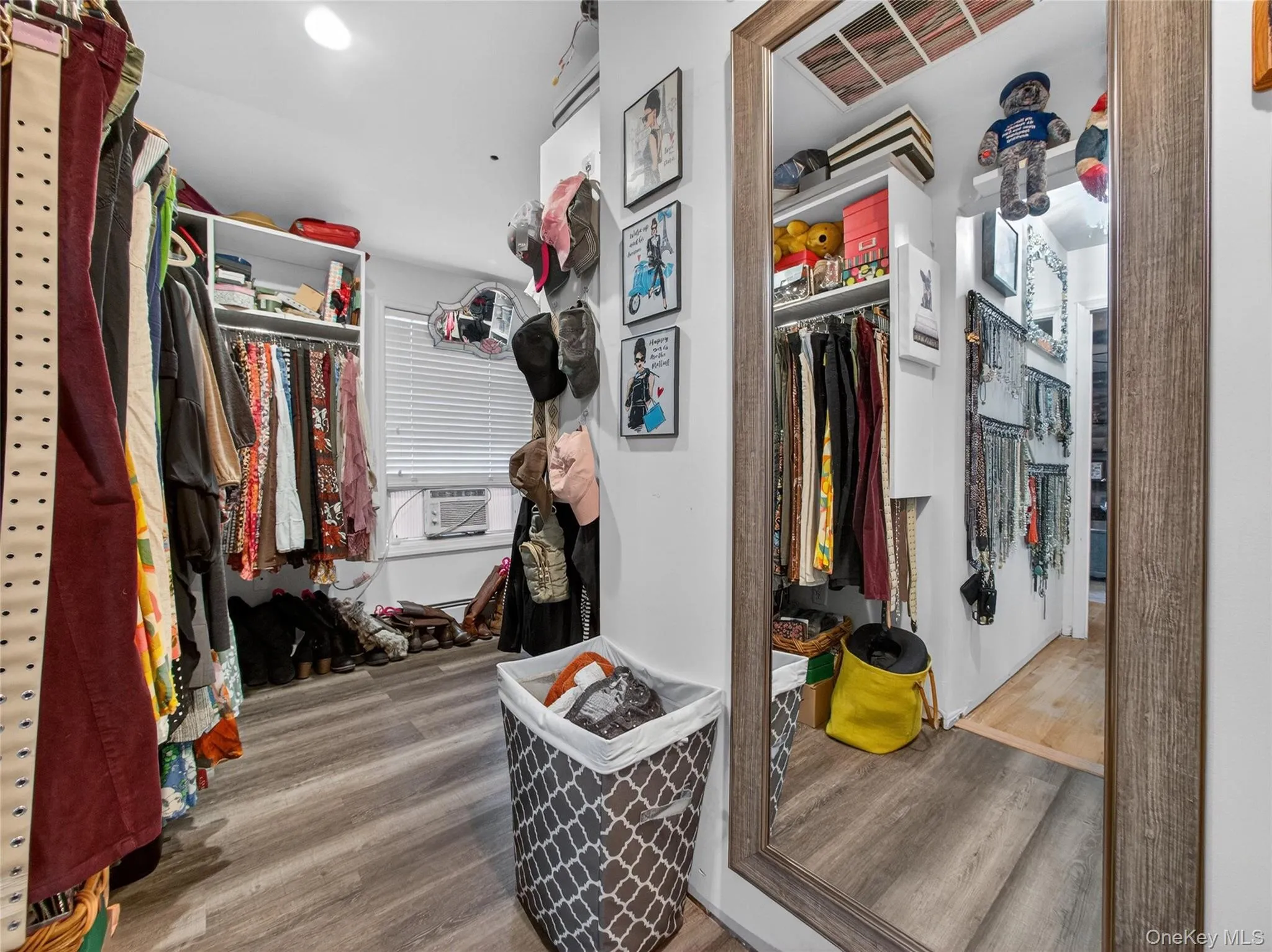 Walk in closet with wood finished floors Walk in closet with wood finished floors