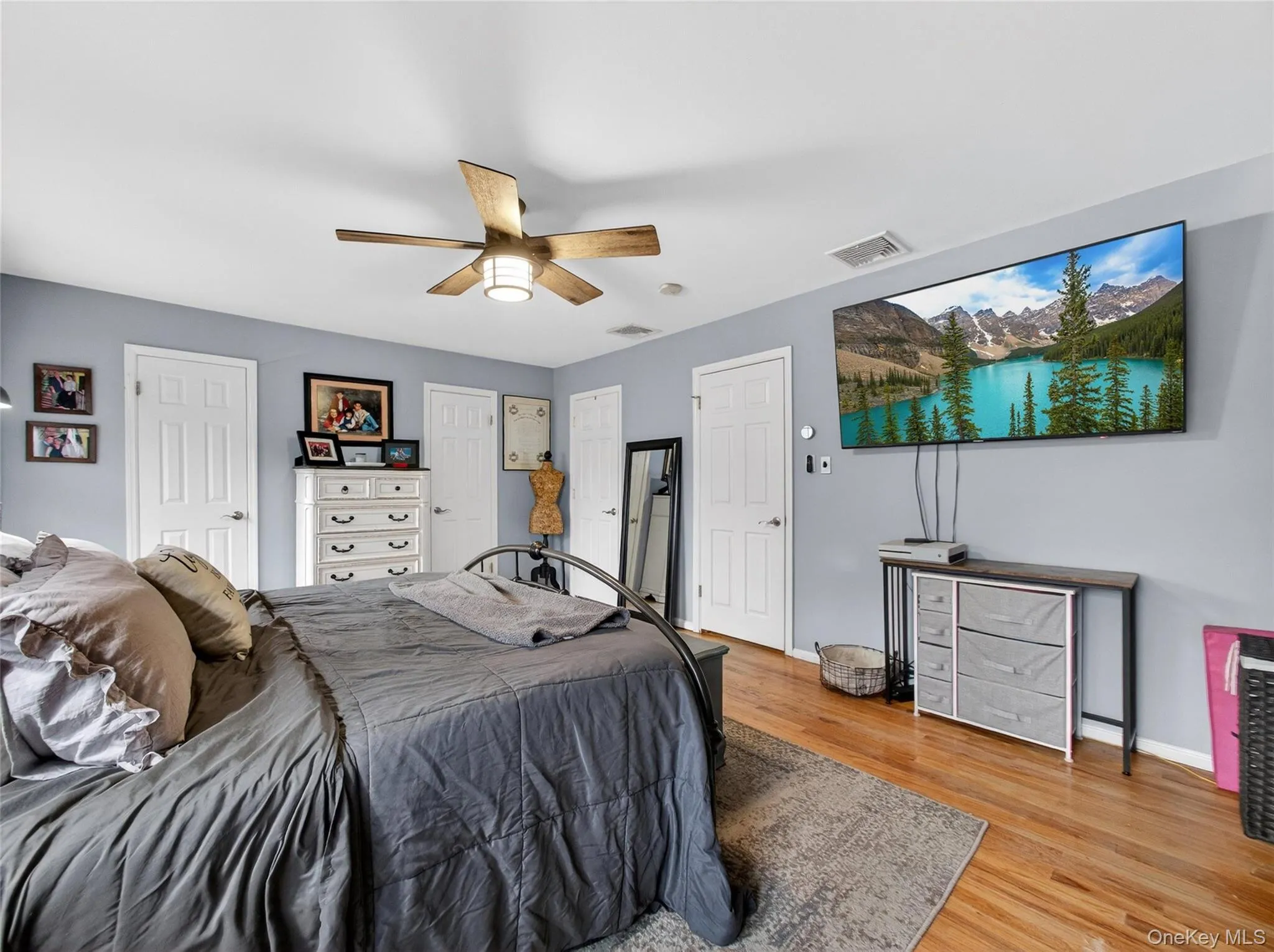 Bedroom featuring light wood-style floors and ceiling fan Bedroom featuring light wood-style floors and ceiling fan