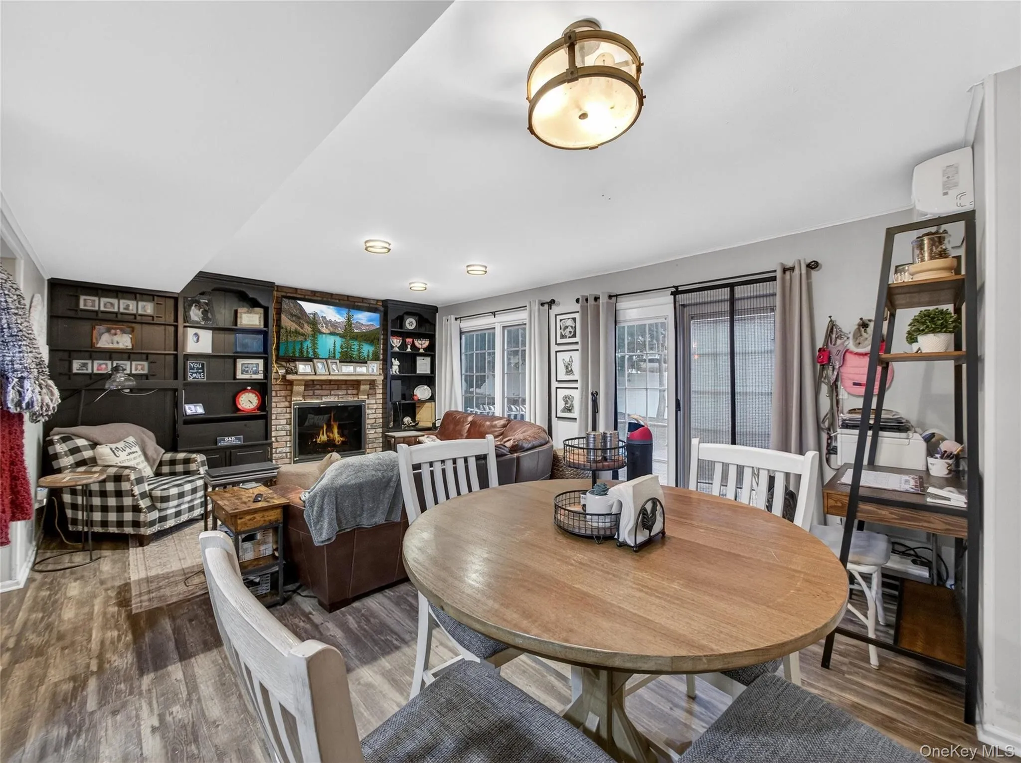 Dining room with wood finished floors, built in features, and a fireplace Dining room with wood finished floors, built in features, and a fireplace