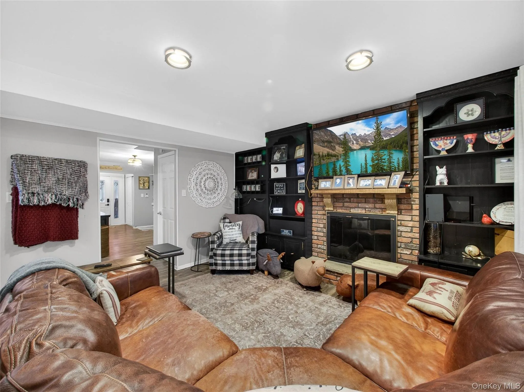 Living area featuring a fireplace and baseboards Living area featuring a fireplace and baseboards