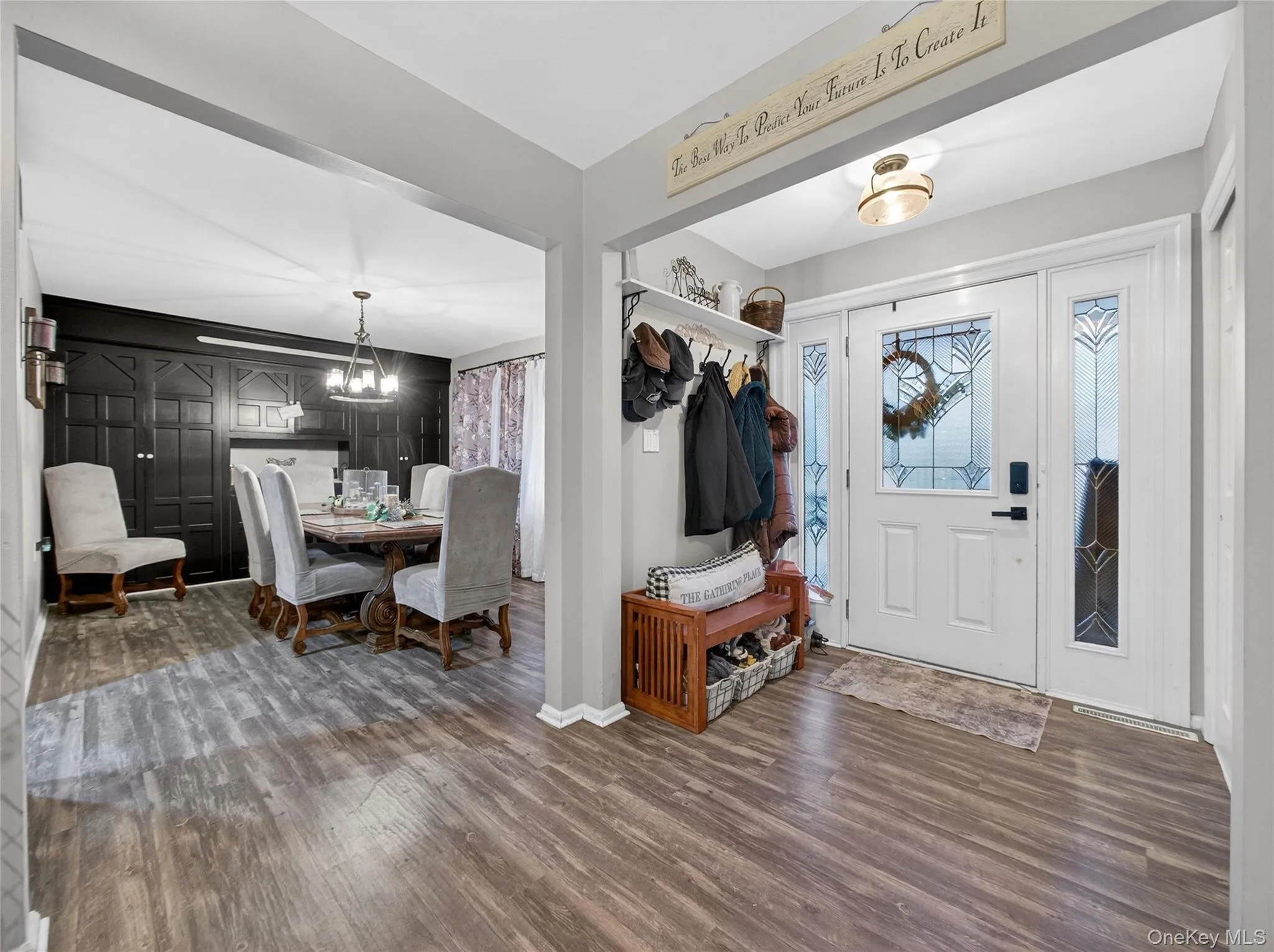 Foyer entrance with wood finished floors and a chandelier Foyer entrance with wood finished floors and a chandelier