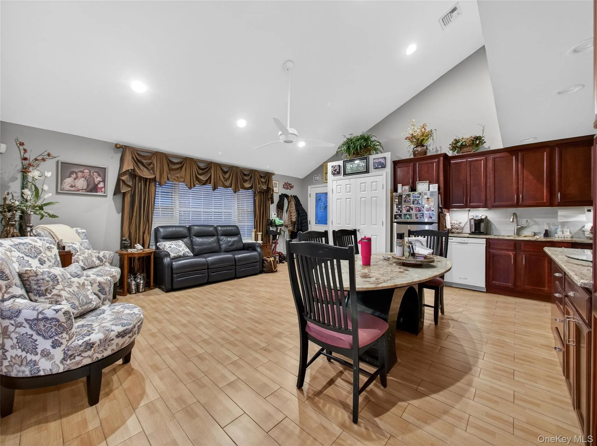 Dining room featuring high vaulted ceiling, wood tiled floors, ceiling fan, and recessed lighting Dining room featuring high vaulted ceiling, wood tiled floors, ceiling fan, and recessed lighting
