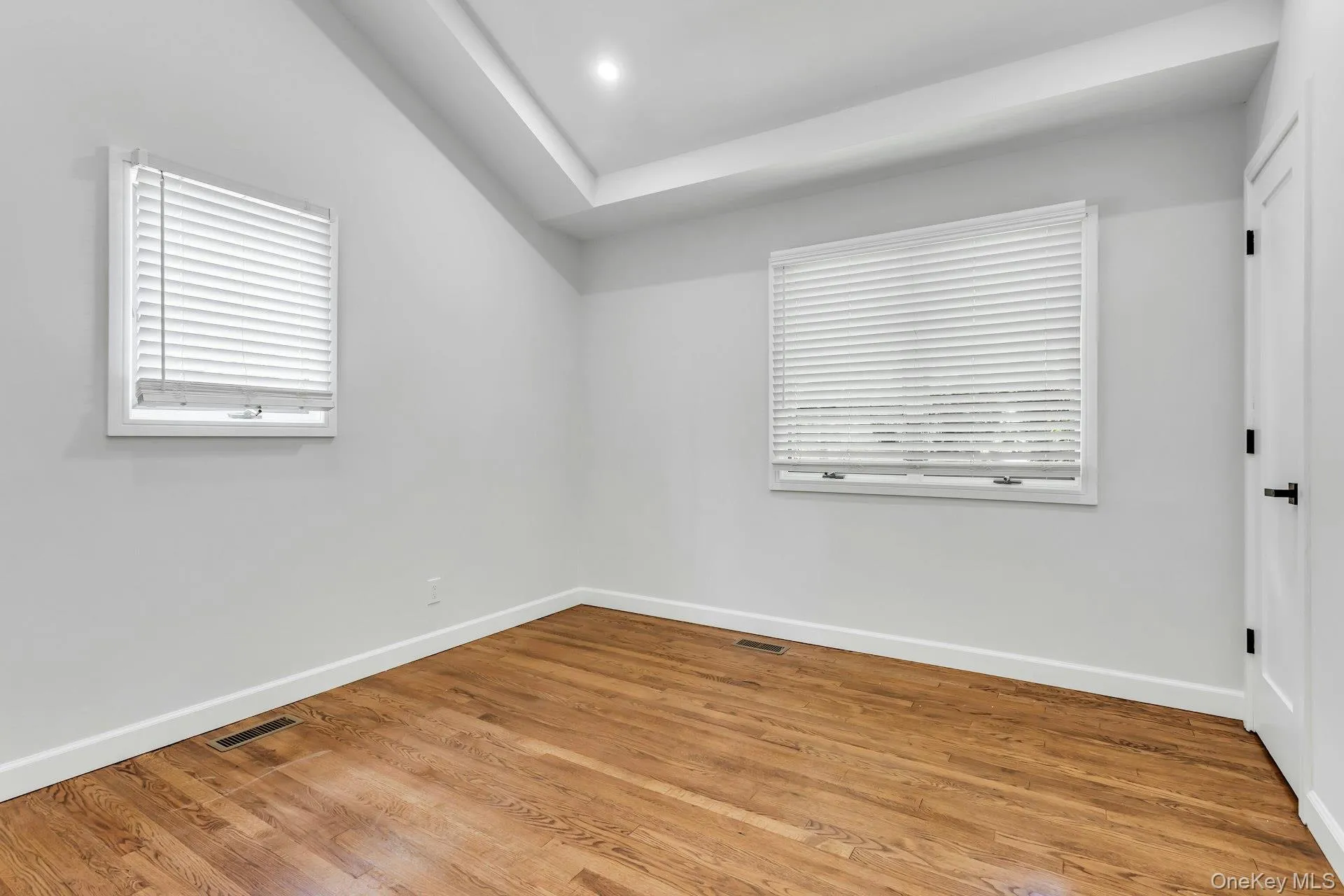Bedroom 1 with vaulted ceiling, Hardwood Floors, Closet and 2 windows Bedroom 1 with vaulted ceiling, Hardwood Floors, Closet and 2 windows