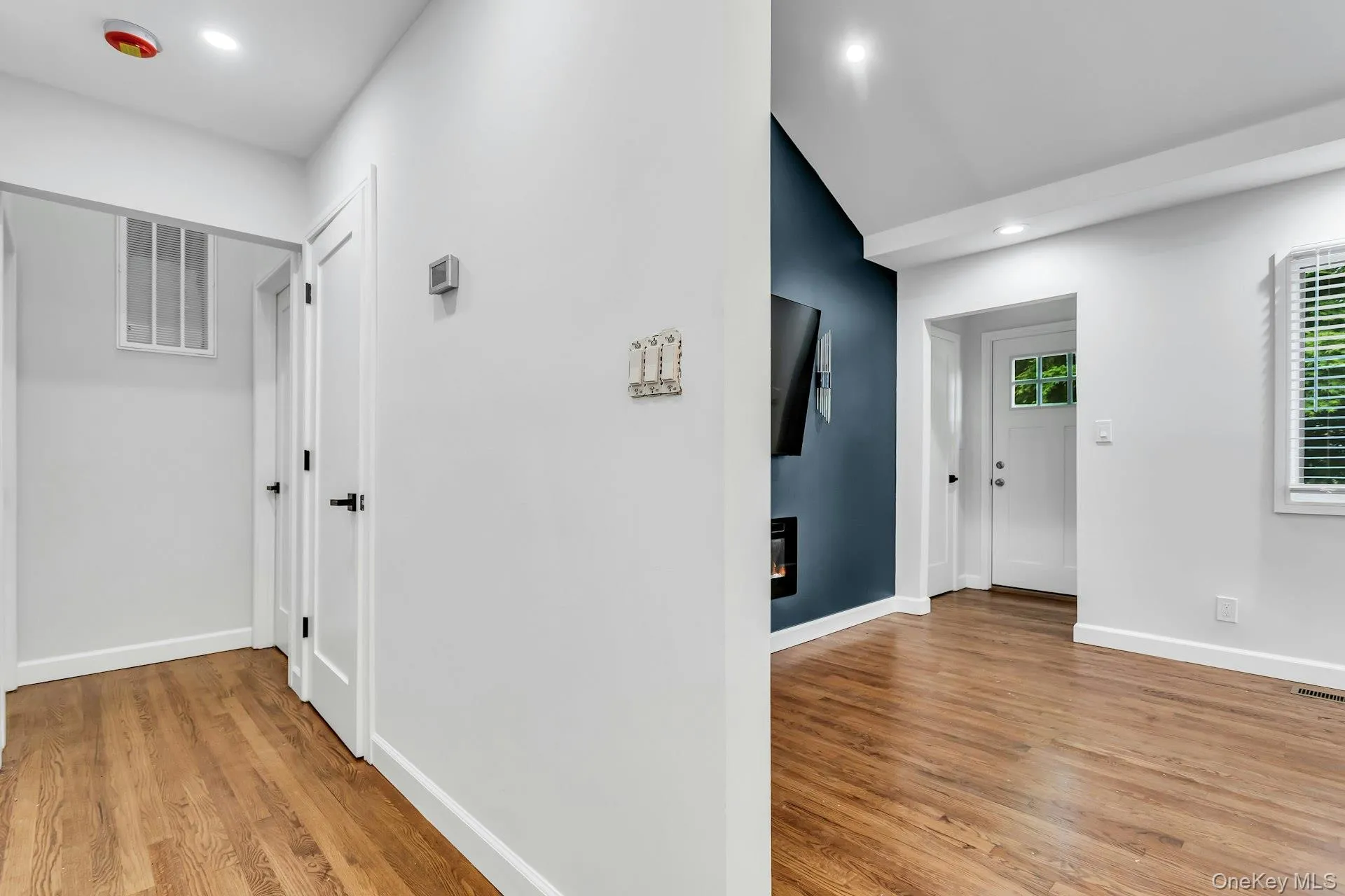 Open concept living space featuring wood-finish flooring Open concept living space featuring wood-finish flooring