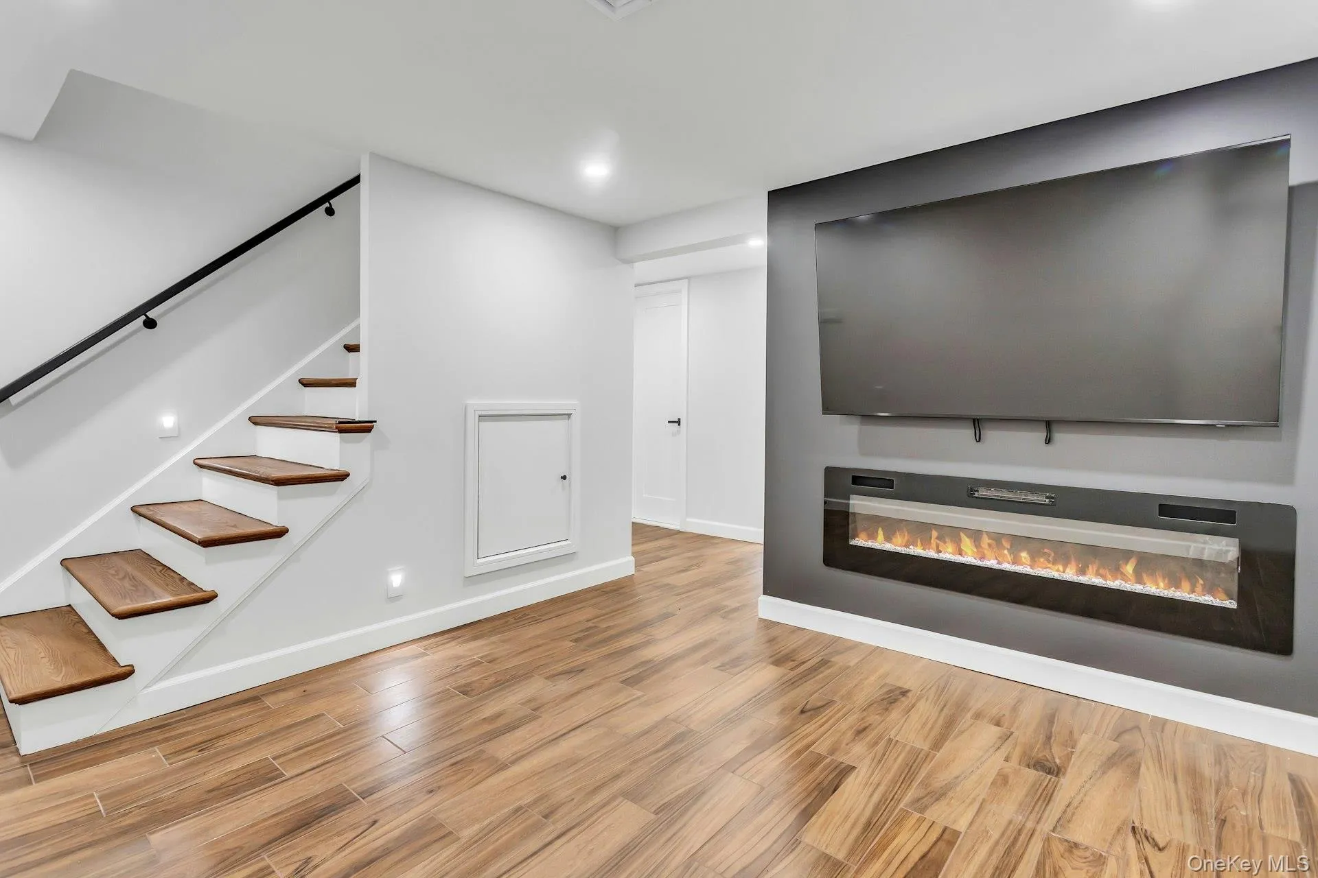 Wood Finished floors with accent wall includes Samsung TV and Electric Fireplace Wood Finished floors with accent wall includes Samsung TV and Electric Fireplace