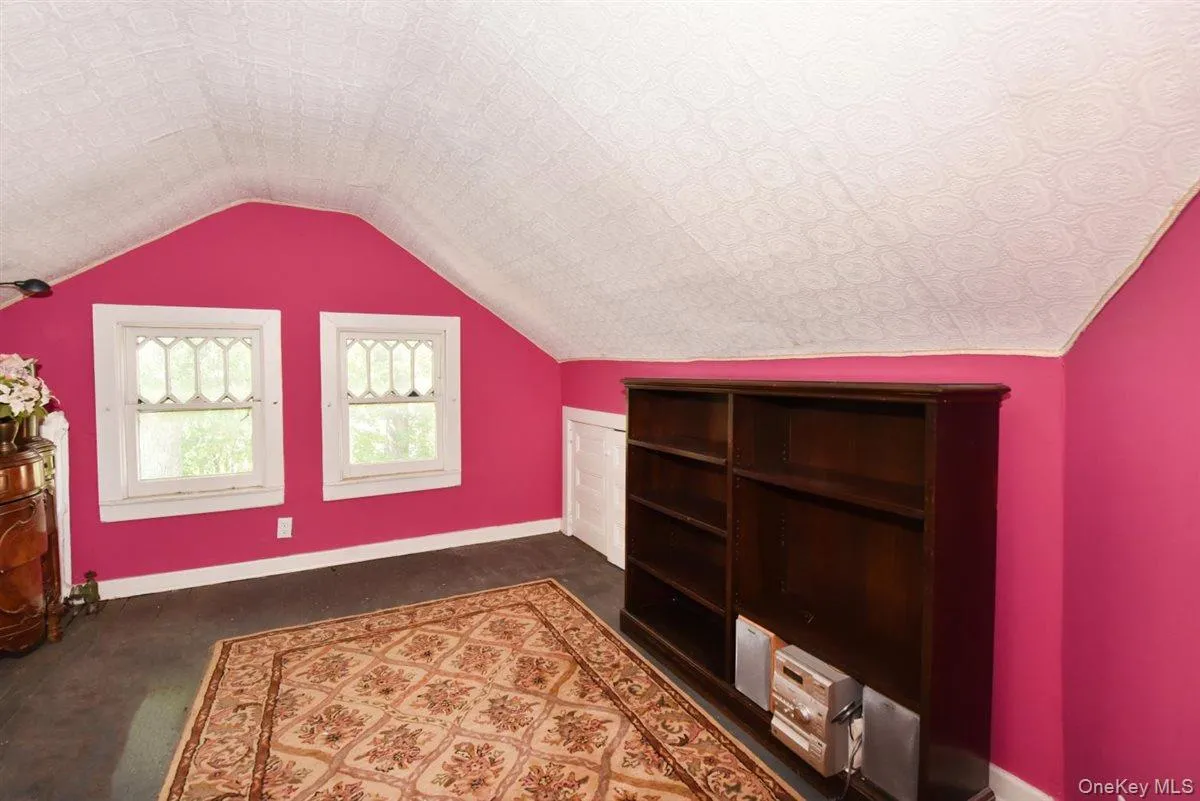 Additional living space featuring baseboards and vaulted ceiling Additional living space featuring baseboards and vaulted ceiling