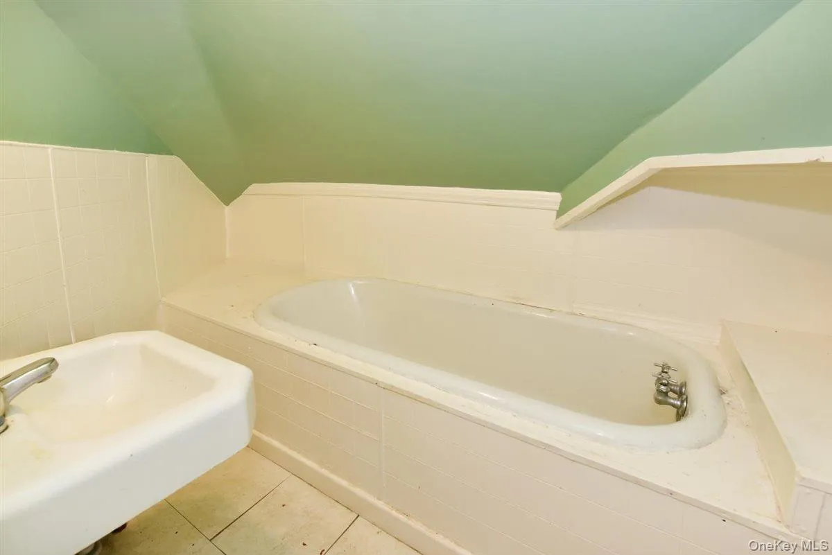 Bathroom featuring a garden tub and tile patterned floors Bathroom featuring a garden tub and tile patterned floors