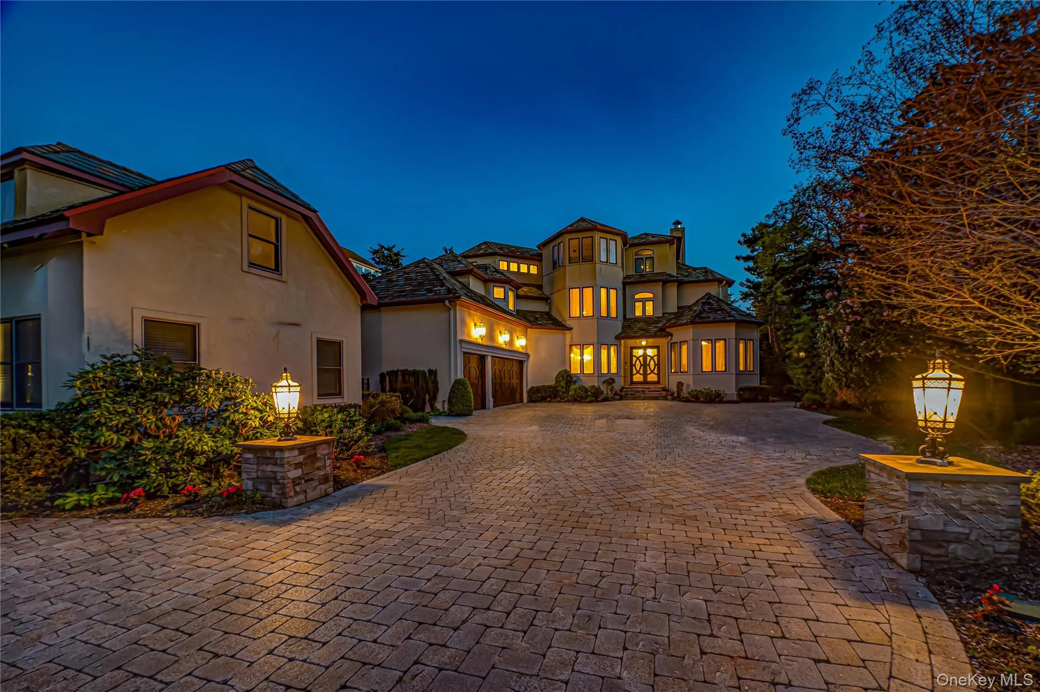 Mediterranean / spanish-style home featuring curved driveway, stucco siding, and a chimney Mediterranean / spanish-style home featuring curved driveway, stucco siding, and a chimney