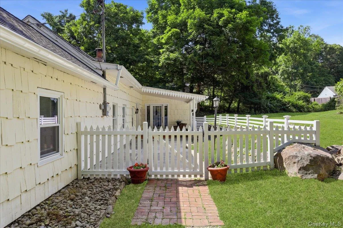 Sweet white picket fence wraps the front patio area. Sweet white picket fence wraps the front patio area.