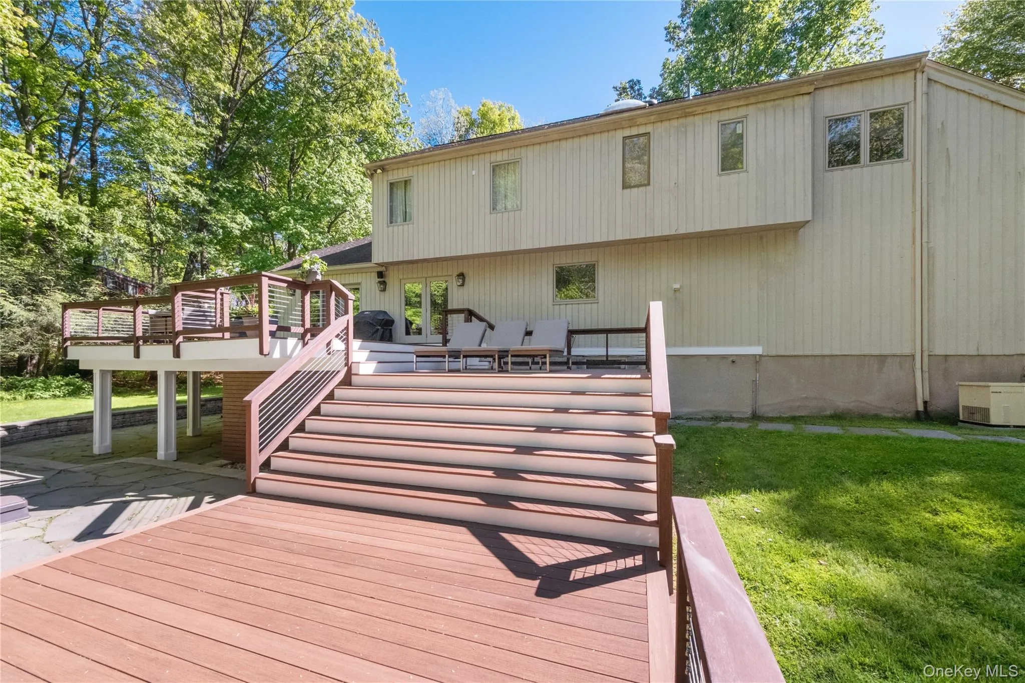 Rear of house showing spacious deck Rear of house showing spacious deck