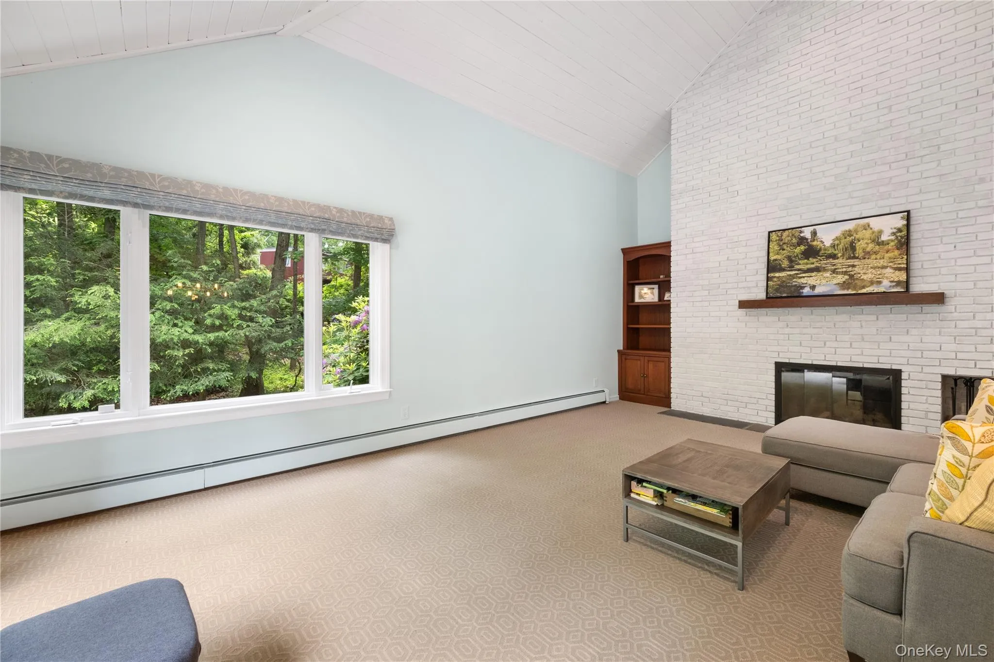 Other angle of family room with wall of windows Other angle of family room with wall of windows