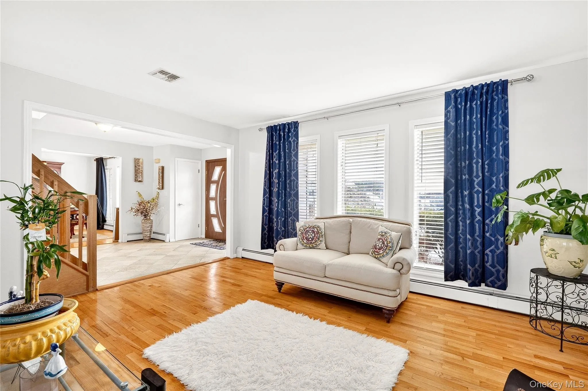 featuring wood-type flooring and a baseboard heating unit featuring wood-type flooring and a baseboard heating unit