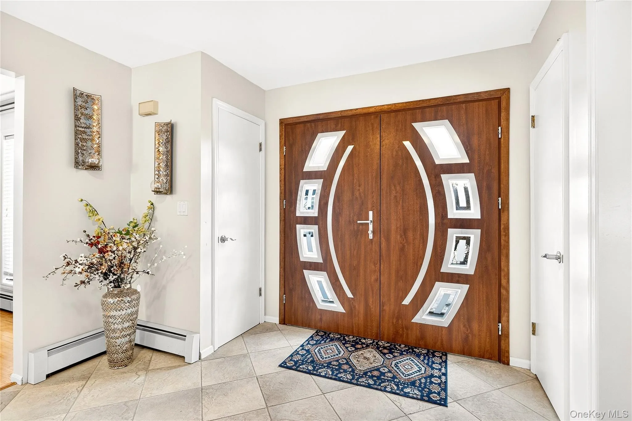 Featuring light tile patterned floors and baseboard heating Featuring light tile patterned floors and baseboard heating