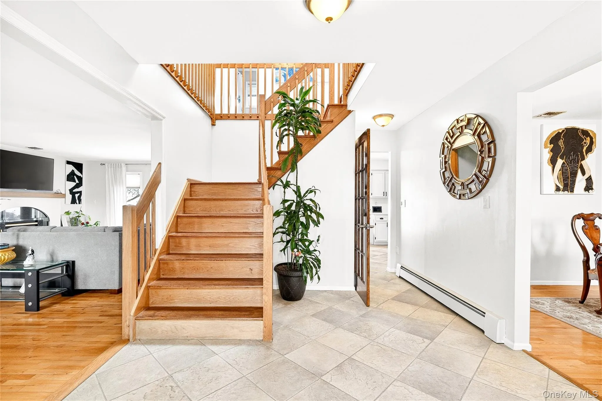 with a baseboard radiator and wood finished floors with a baseboard radiator and wood finished floors