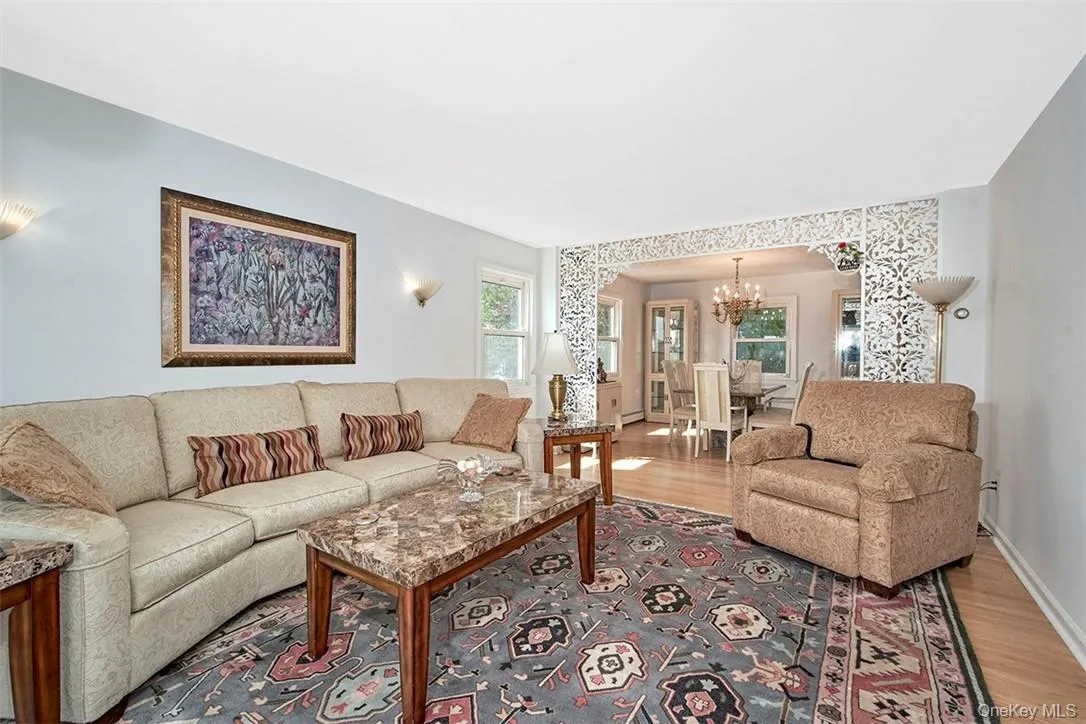 Living room featuring light hardwood / wood-style floors and a chandelier Living room featuring light hardwood / wood-style floors and a chandelier