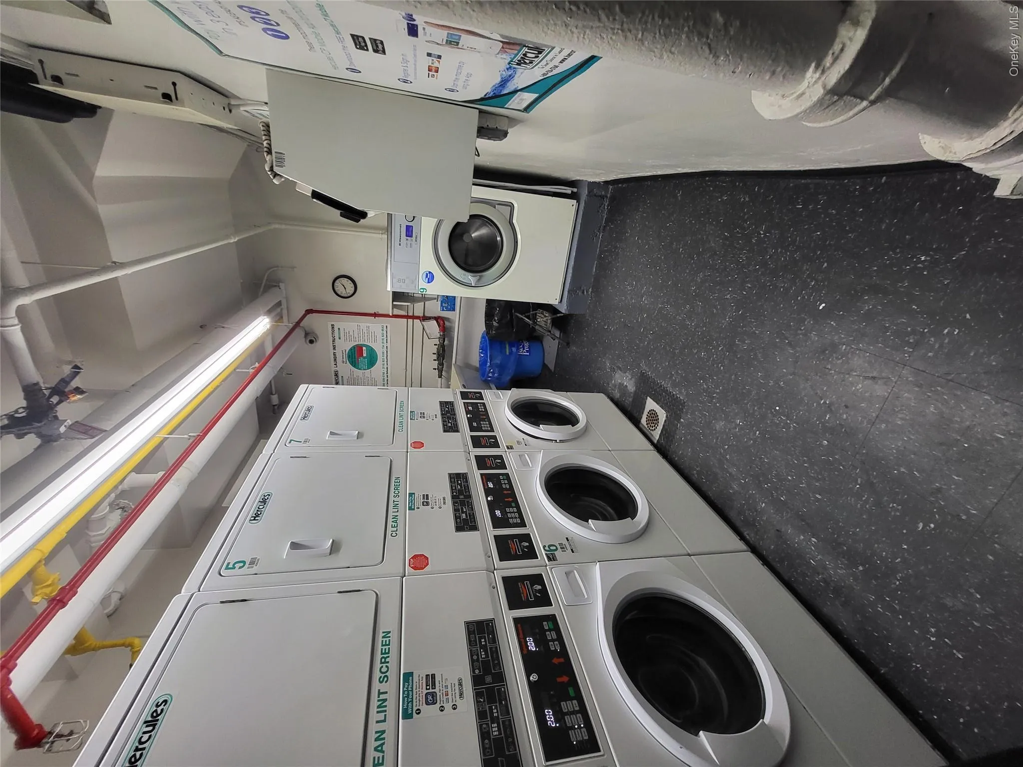Dedicated laundry facility featuring multiple front-loading washers and stacked dryers Dedicated laundry facility featuring multiple front-loading washers and stacked dryers