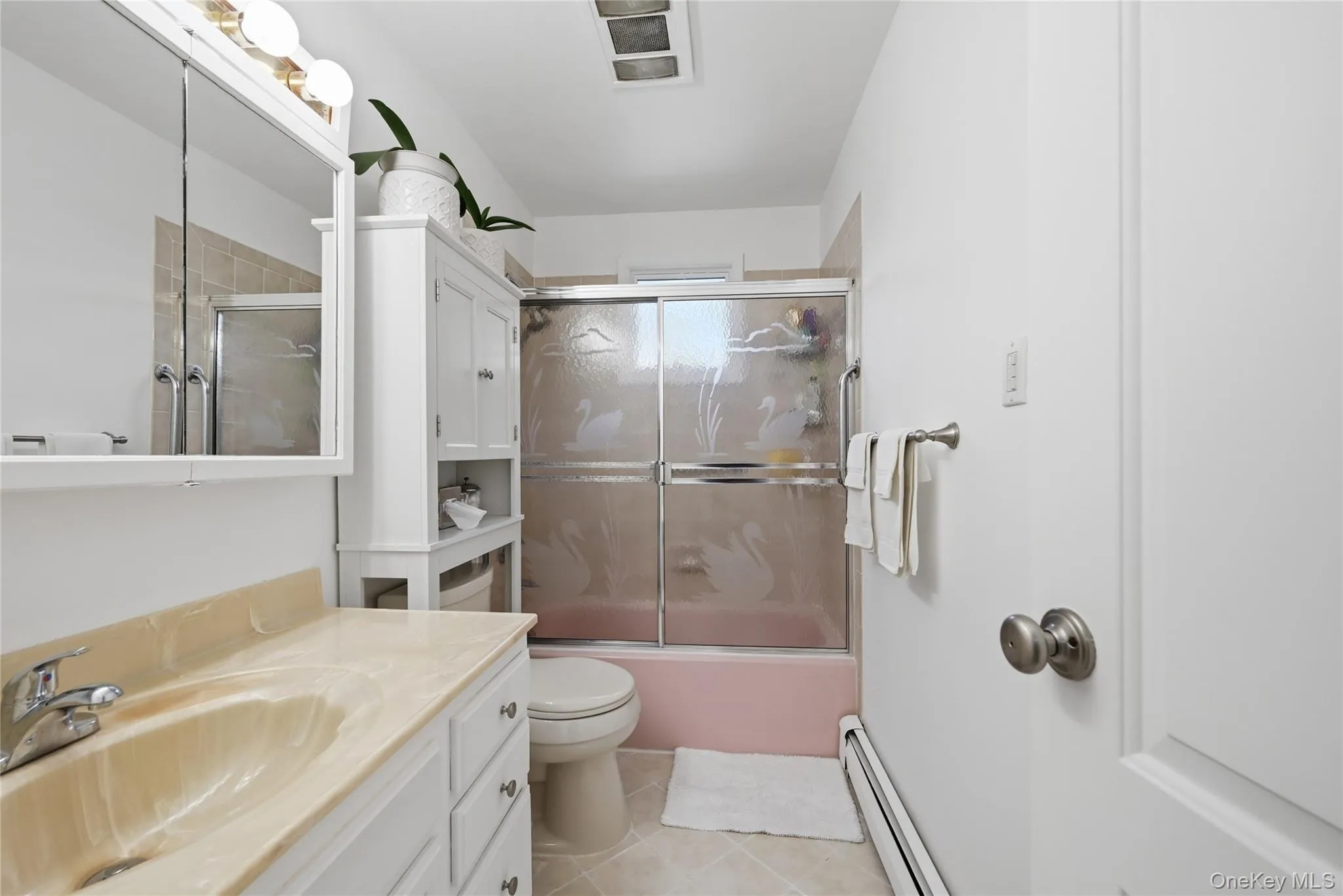 1st floor bathroom with single vanity and adjacent linen closet 1st floor bathroom with single vanity and adjacent linen closet