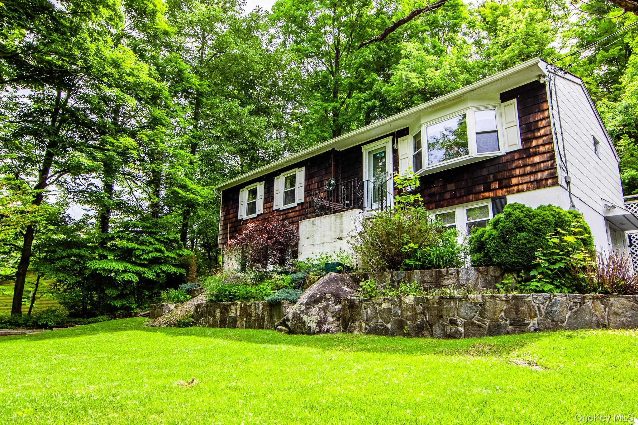 Beautiful flat front yard with stone retaining walls Beautiful flat front yard with stone retaining walls