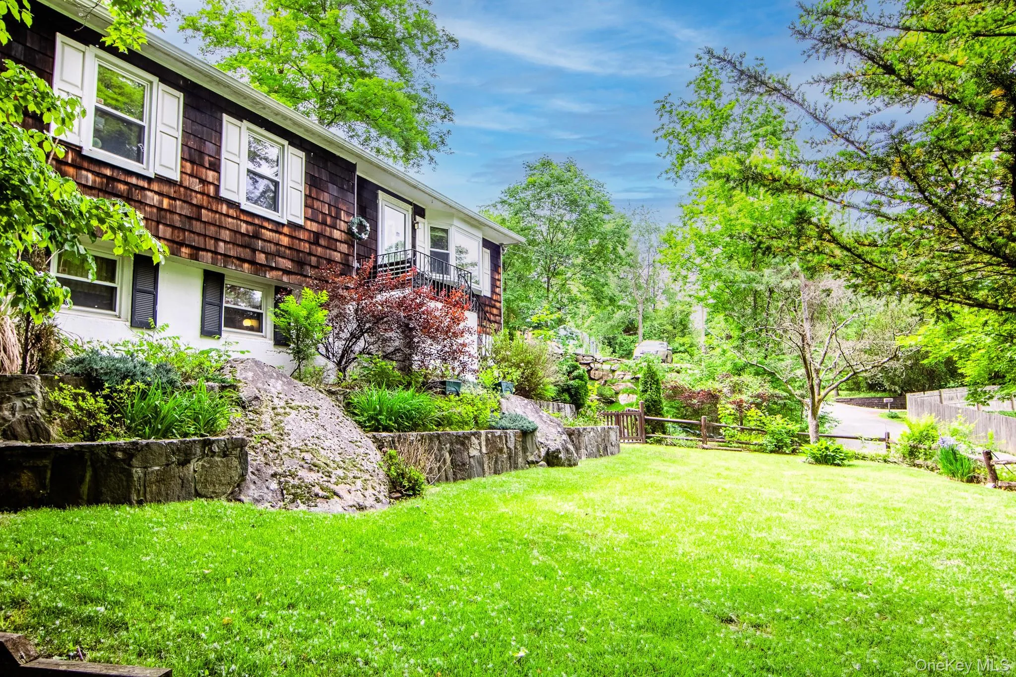 Beautiful flat front yard with stone retaining walls Beautiful flat front yard with stone retaining walls