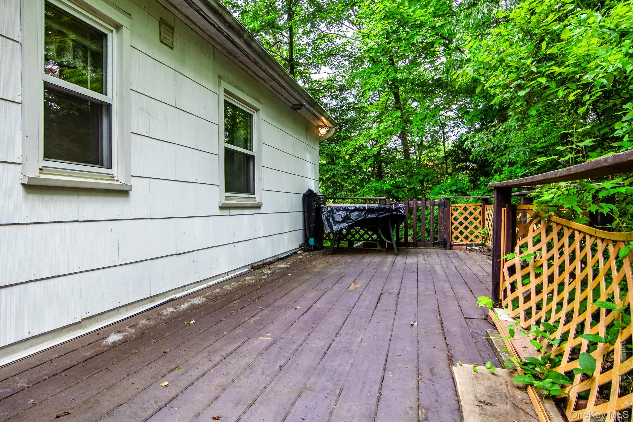 Back deck which leads to another sitting area on the side of the house Back deck which leads to another sitting area on the side of the house