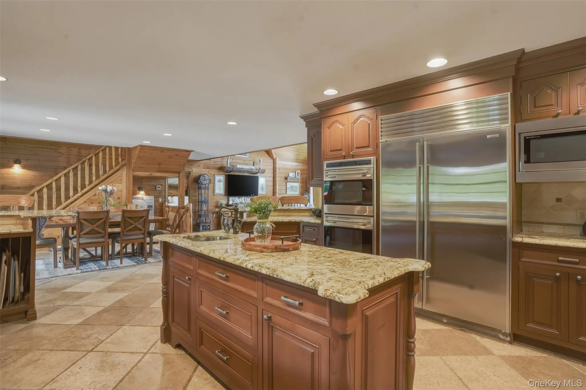 Inside, the home showcases rich wood craftsmanship, soaring ceilings, and breathtaking views of the surrounding mountains, koi ponds, and manicured gardens. The chef's kitchen features custom wood cabinetry, granite countertops, a center island, and spacious dining area, while a practical mudroom includes a convenient dog washing station. Inside, the home showcases rich wood craftsmanship, soaring ceilings, and breathtaking views of the surrounding mountains, koi ponds, and manicured gardens. The chef's kitchen features custom wood cabinetry, granite countertops, a center island, and spacious dining area, while a practical mudroom includes a convenient dog washing station.