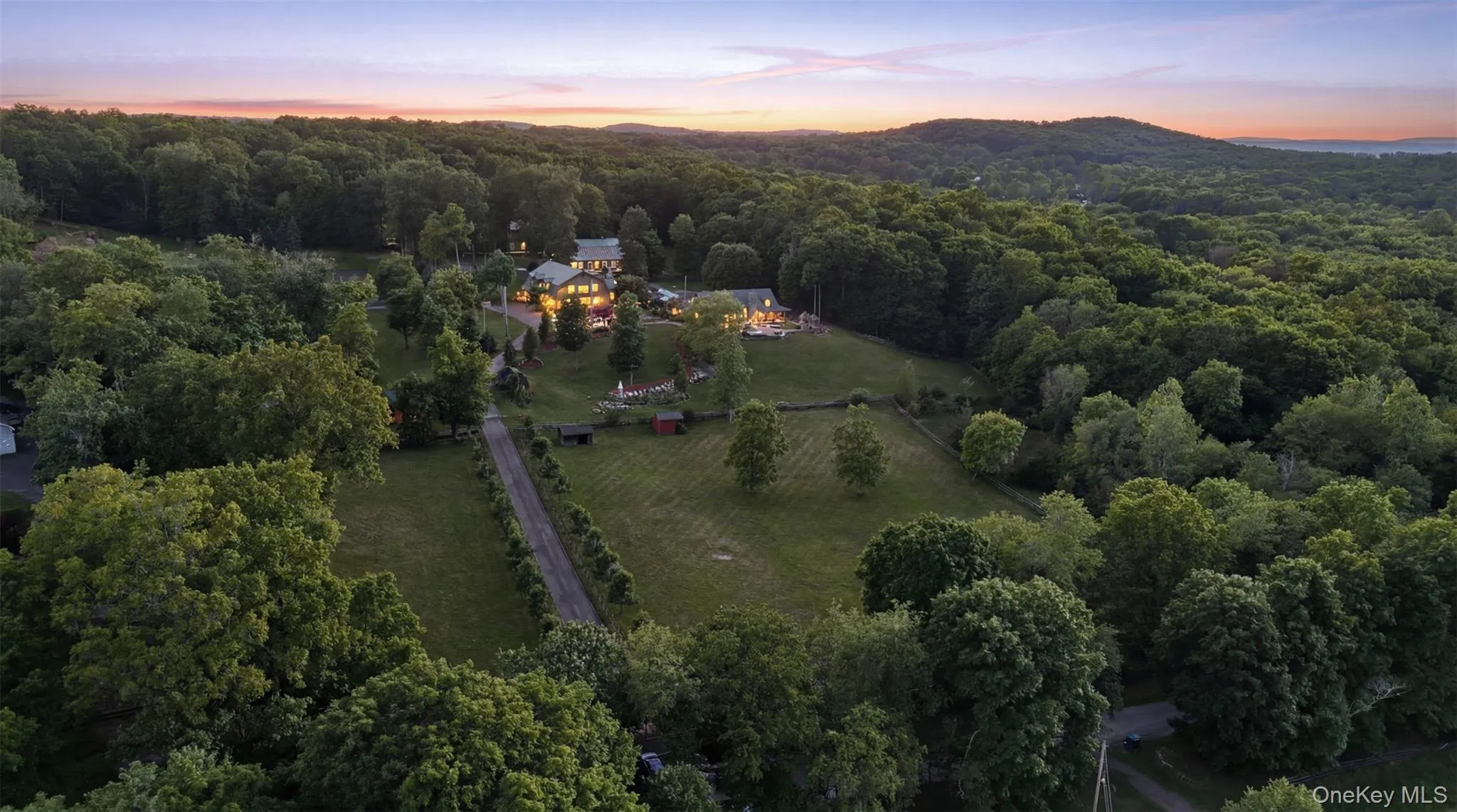 Aerial view of the front of the house, paddocks and surrounding views. Known locally as the famed "Orange County Choppers House," this remarkable property blends rustic elegance with modern comfort in a setting designed for those who appreciate both refined living and outdoor adventure. Aerial view of the front of the house, paddocks and surrounding views. Known locally as the famed "Orange County Choppers House," this remarkable property blends rustic elegance with modern comfort in a setting designed for those who appreciate both refined living and outdoor adventure.