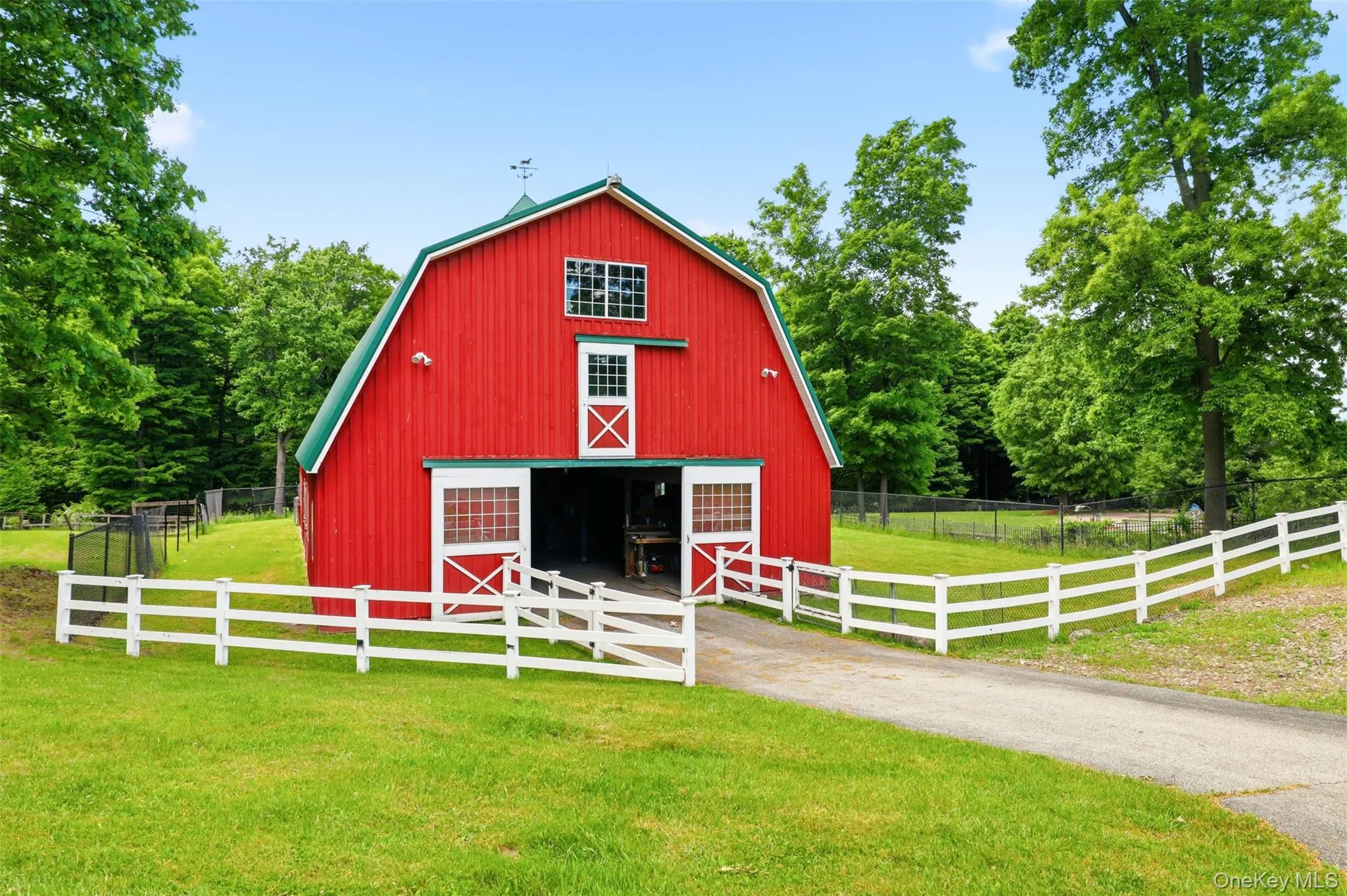 Equestrian enthusiasts will appreciate the substantial two-story barn currently configured for five horses with room for expansion, along with a massive hay loft, multiple fenced paddocks, and supporting outbuildings. A separate mechanic's garage and workshop sits farther down the drive, providing privacy and flexibility for hobbyists, collectors, or business pursuits. Equestrian enthusiasts will appreciate the substantial two-story barn currently configured for five horses with room for expansion, along with a massive hay loft, multiple fenced paddocks, and supporting outbuildings. A separate mechanic's garage and workshop sits farther down the drive, providing privacy and flexibility for hobbyists, collectors, or business pursuits.