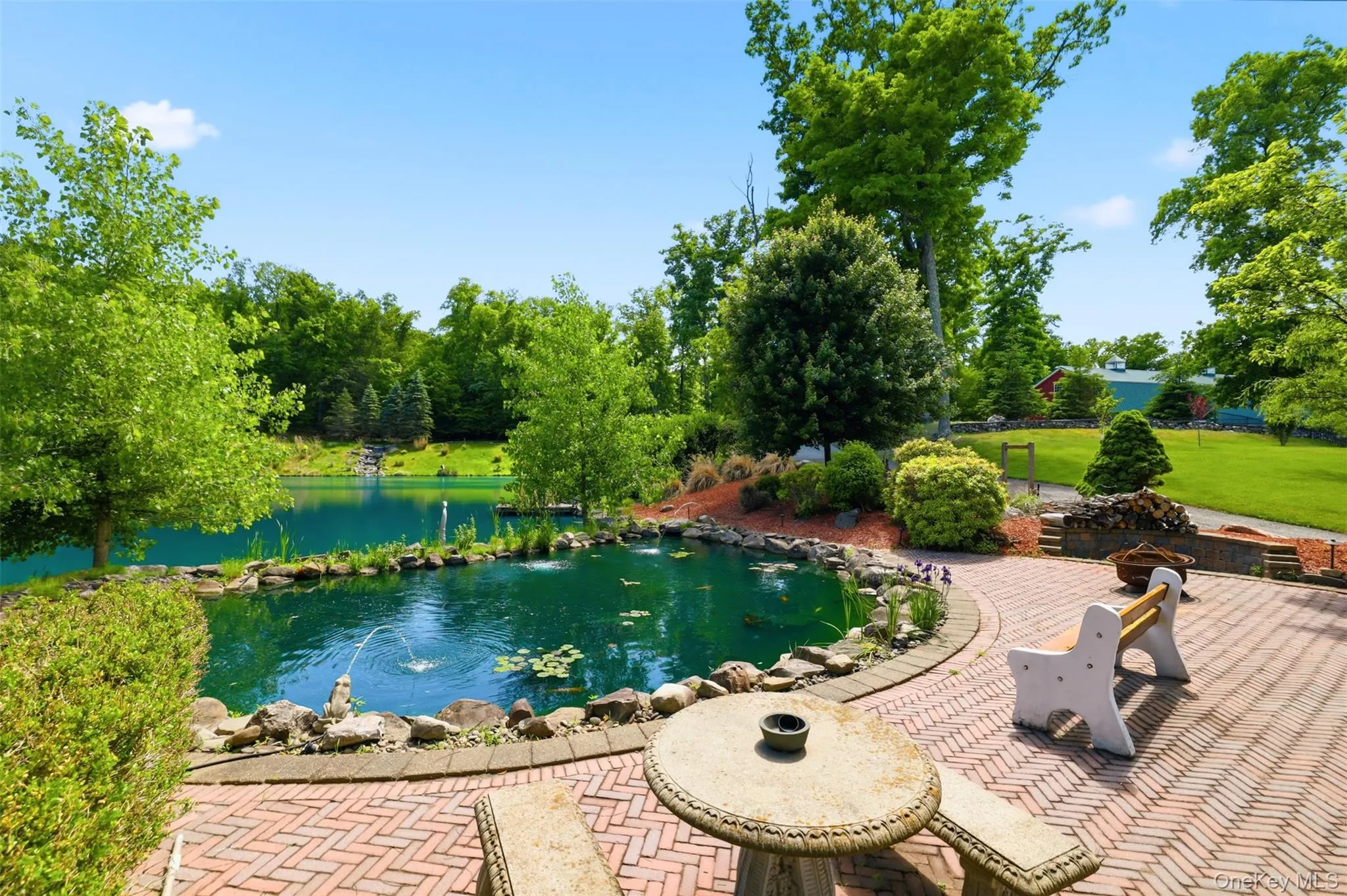 Smaller koi pond that looks over the 1 acre pond. Patio with shed, firepit and grilling station Smaller koi pond that looks over the 1 acre pond. Patio with shed, firepit and grilling station