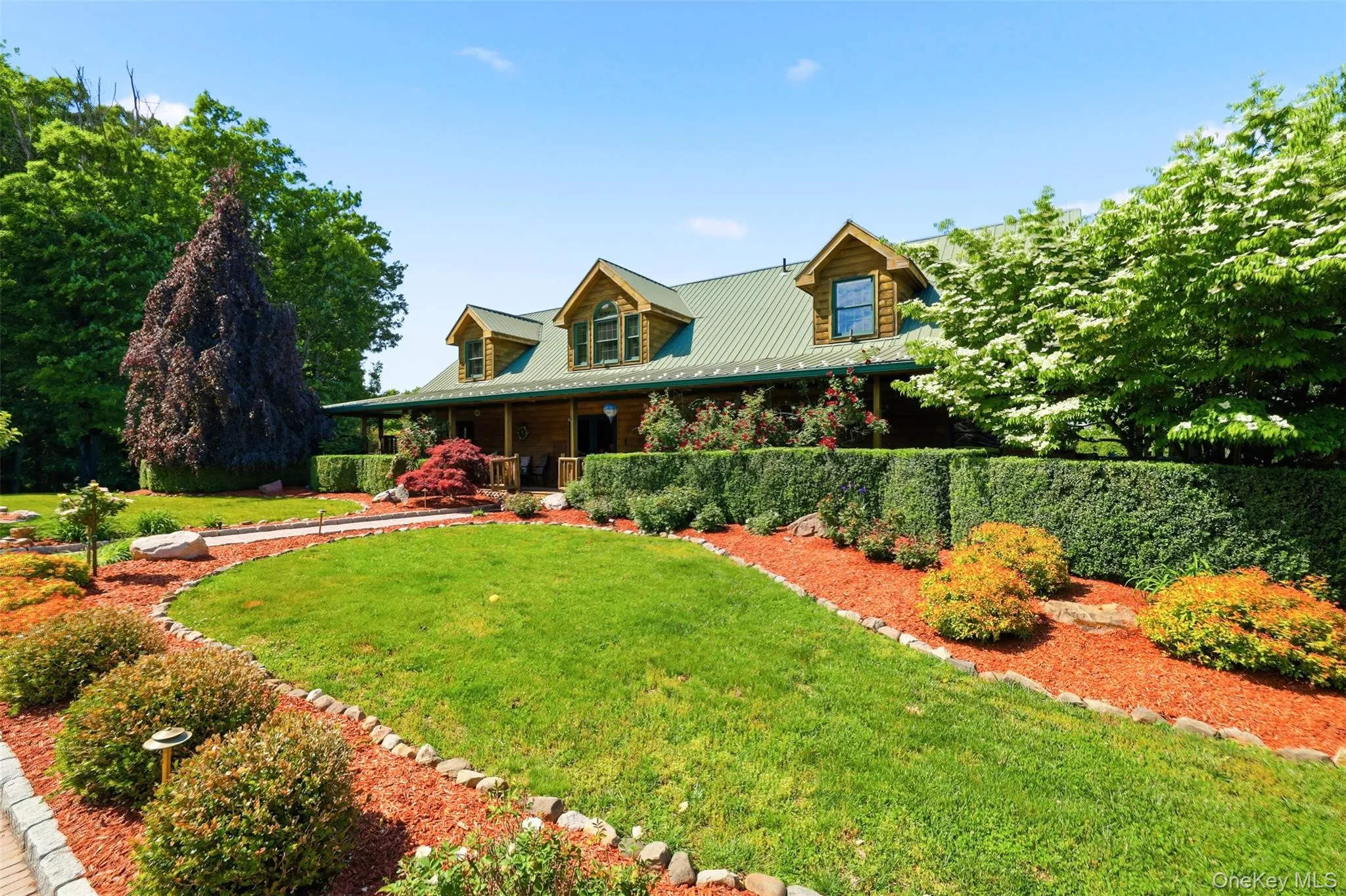 Beyond the gated entrance, a winding driveway passes fenced paddocks, open meadows, and animal outbuildings before arriving at the impressive log home, complete with a wraparound covered porch, metal roof, and expansive courtyard driveway with ample space for oversized vehicles and equipment. Beyond the gated entrance, a winding driveway passes fenced paddocks, open meadows, and animal outbuildings before arriving at the impressive log home, complete with a wraparound covered porch, metal roof, and expansive courtyard driveway with ample space for oversized vehicles and equipment.