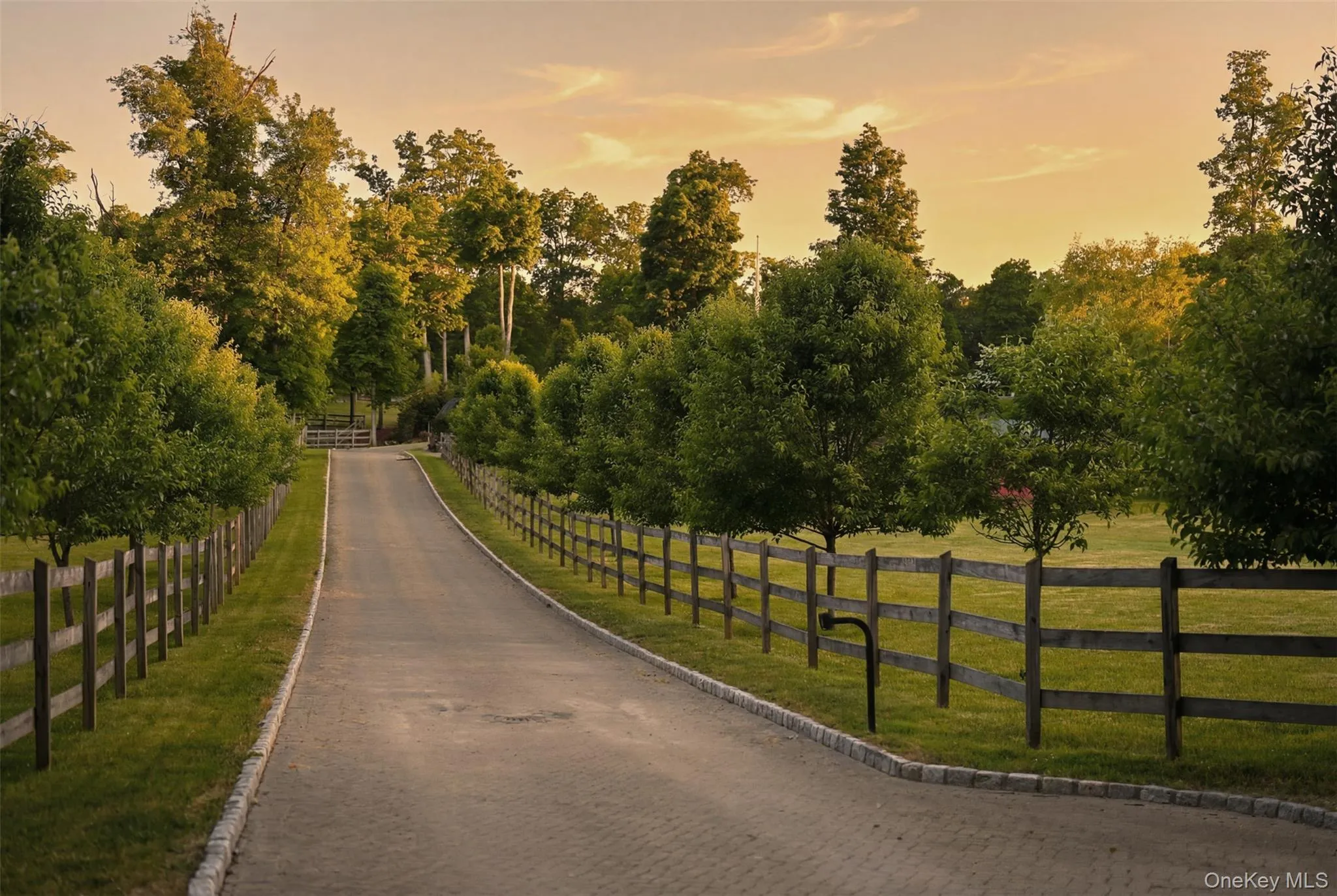 Concrete paver driveway with Belgian block curb, Beyond the gated entrance, a winding driveway passes fenced paddocks, open meadows, and animal outbuildings before arriving at the impressive log home, complete with a wraparound covered porch, metal roof, and expansive courtyard driveway with ample space for oversized vehicles and equipment. Concrete paver driveway with Belgian block curb, Beyond the gated entrance, a winding driveway passes fenced paddocks, open meadows, and animal outbuildings before arriving at the impressive log home, complete with a wraparound covered porch, metal roof, and expansive courtyard driveway with ample space for oversized vehicles and equipment.