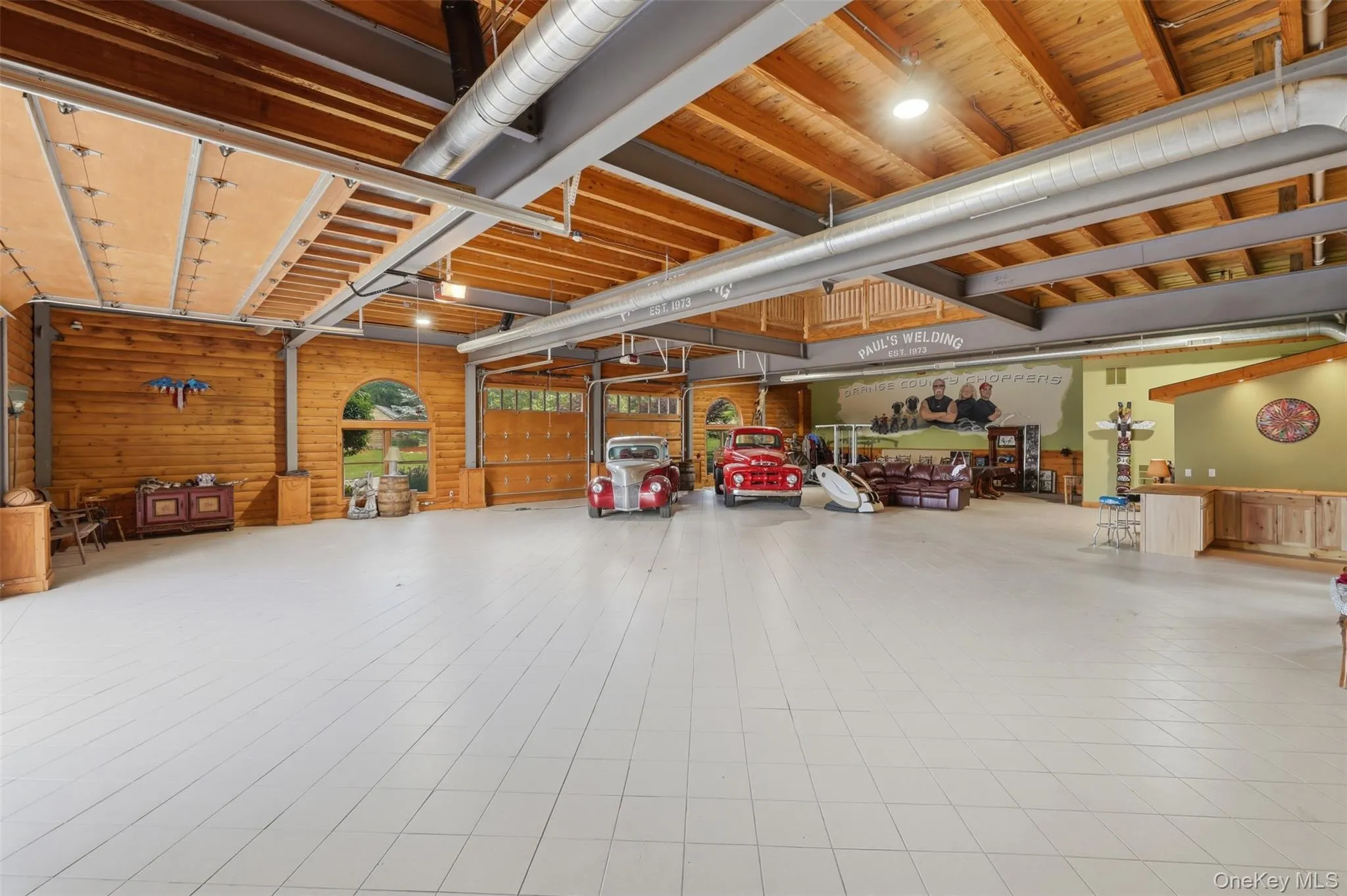 The estate continues to impress with a heated two-story showroom garage offering over 7,000 square feet of space. The upper level includes two guest apartments, each with kitchenettes, bedrooms, and bathrooms, creating exceptional opportunities for extended family, guests, or staff accommodations. The estate continues to impress with a heated two-story showroom garage offering over 7,000 square feet of space. The upper level includes two guest apartments, each with kitchenettes, bedrooms, and bathrooms, creating exceptional opportunities for extended family, guests, or staff accommodations.