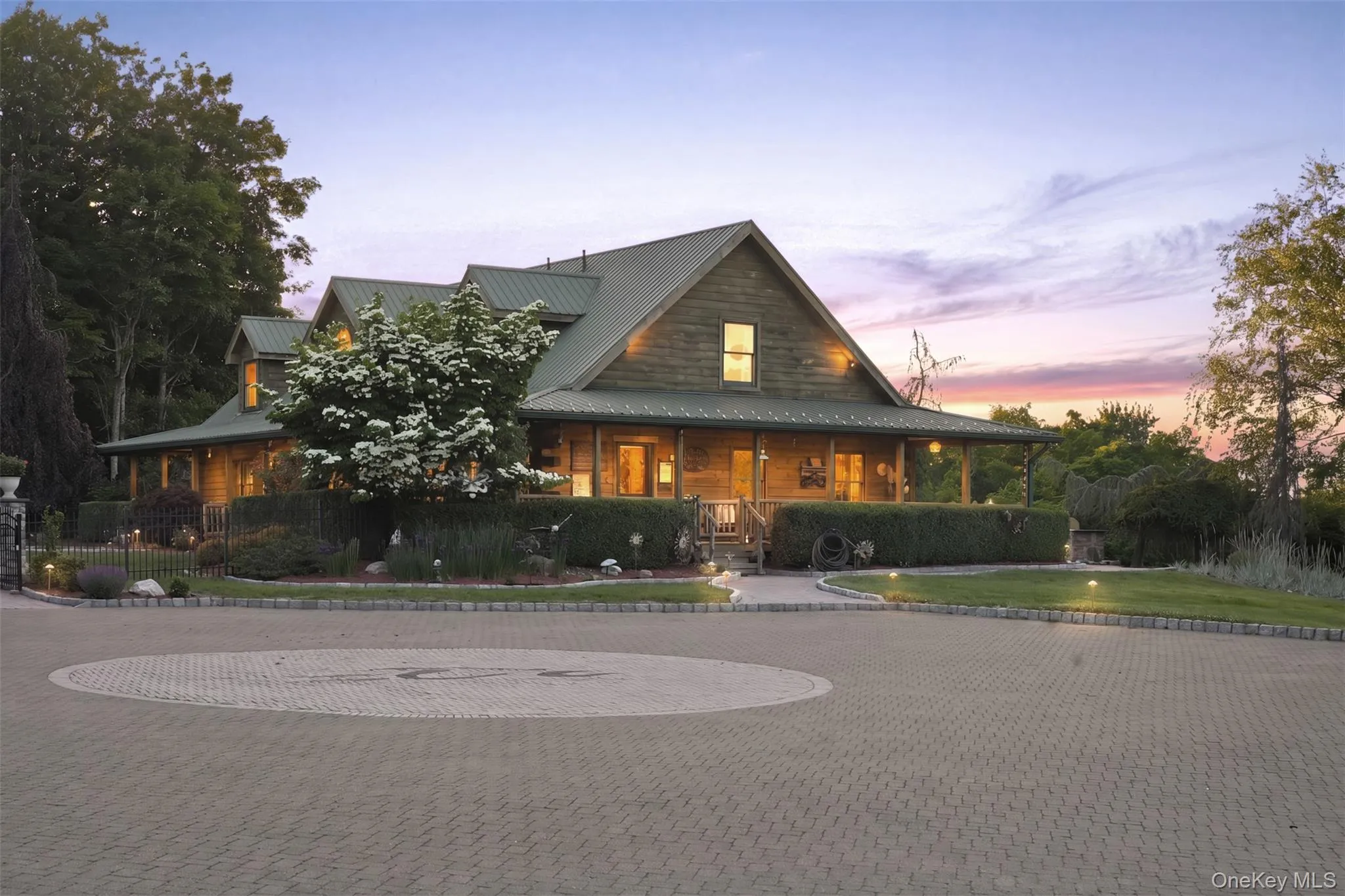 Beyond the gated entrance, a winding driveway passes fenced paddocks, open meadows, and animal outbuildings before arriving at the impressive log home, complete with a wraparound covered porch, metal roof, and expansive courtyard driveway with ample space for oversized vehicles and equipment. Beyond the gated entrance, a winding driveway passes fenced paddocks, open meadows, and animal outbuildings before arriving at the impressive log home, complete with a wraparound covered porch, metal roof, and expansive courtyard driveway with ample space for oversized vehicles and equipment.