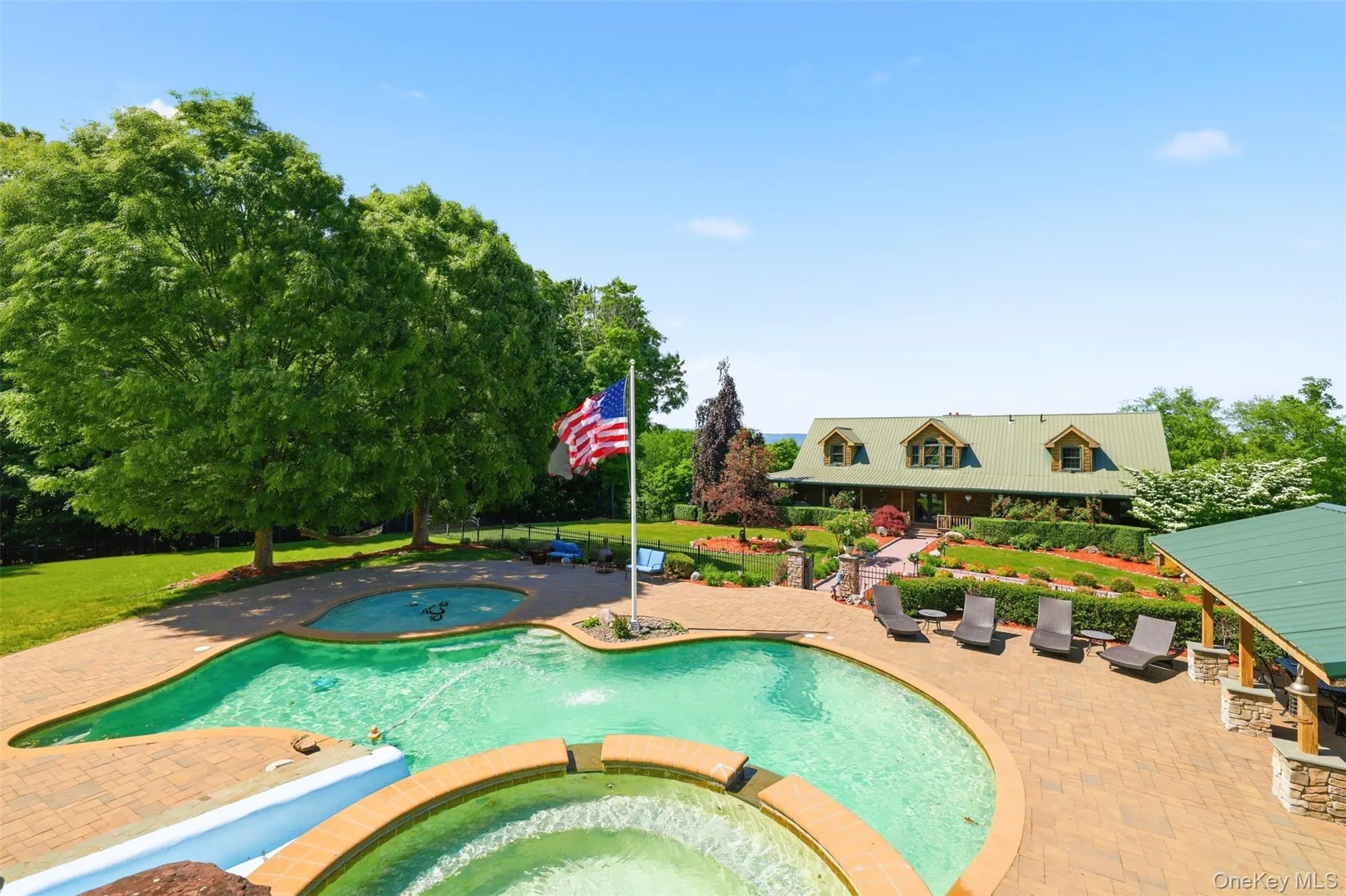 Step outside and discover a true resort-style oasis. The spectacular multi-level heated pool features a slide, wading area, and extensive lounging spaces. The pool house includes a tiki bar, full bathroom, and outdoor shower, while dual Thor grills, granite serving stations, and a shaded pergola create the ultimate setting for unforgettable gatherings. Step outside and discover a true resort-style oasis. The spectacular multi-level heated pool features a slide, wading area, and extensive lounging spaces. The pool house includes a tiki bar, full bathroom, and outdoor shower, while dual Thor grills, granite serving stations, and a shaded pergola create the ultimate setting for unforgettable gatherings.