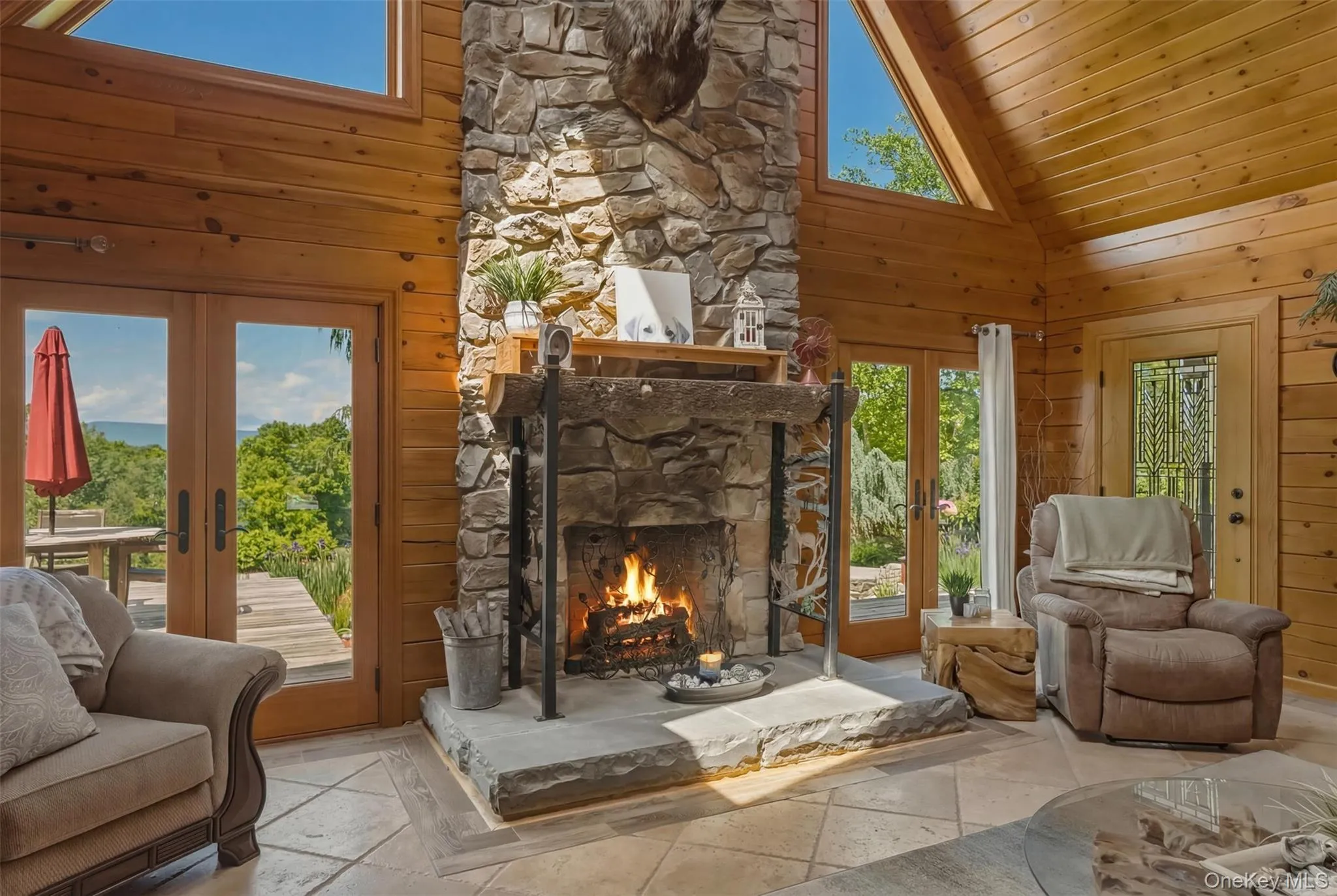 Handsome stone fireplace, doors out to the front patio/deck with mountain views, koi pond and grilling station (1 of 3) Handsome stone fireplace, doors out to the front patio/deck with mountain views, koi pond and grilling station (1 of 3)