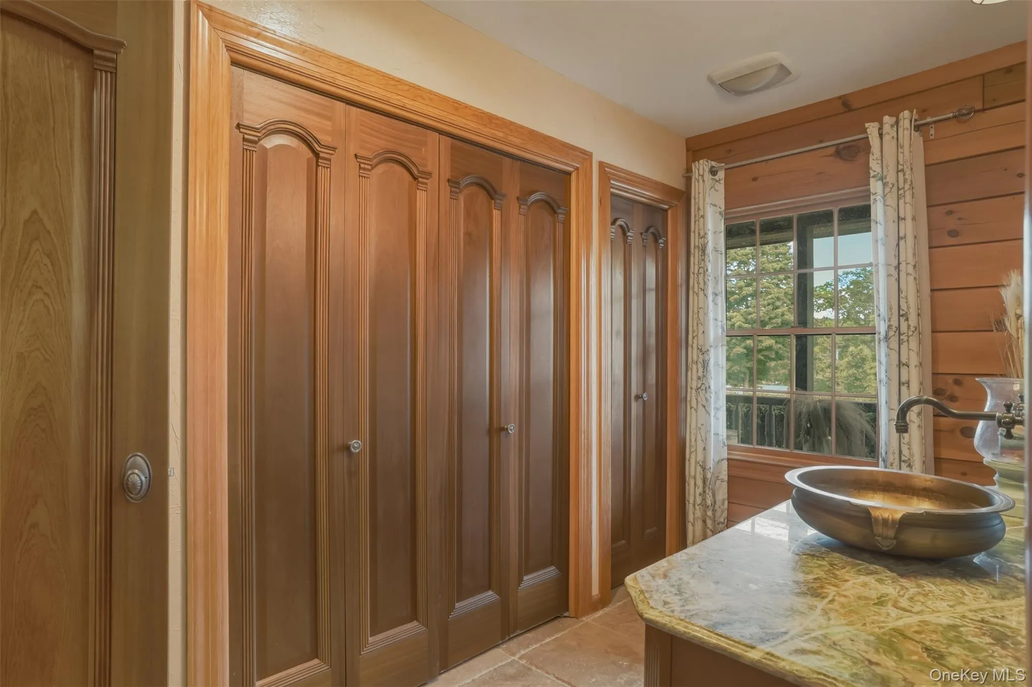 Main level shared bathroom with laundry and storage closet Main level shared bathroom with laundry and storage closet
