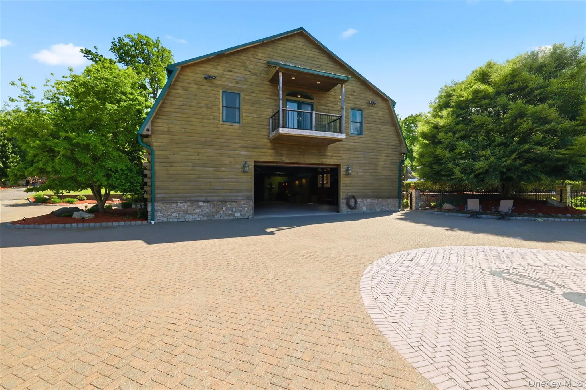 The estate continues to impress with a heated two-story showroom garage offering over 7,000 square feet of space. The upper level includes two guest apartments, each with kitchenettes, bedrooms, and bathrooms, creating exceptional opportunities for extended family, guests, or staff accommodations. The estate continues to impress with a heated two-story showroom garage offering over 7,000 square feet of space. The upper level includes two guest apartments, each with kitchenettes, bedrooms, and bathrooms, creating exceptional opportunities for extended family, guests, or staff accommodations.