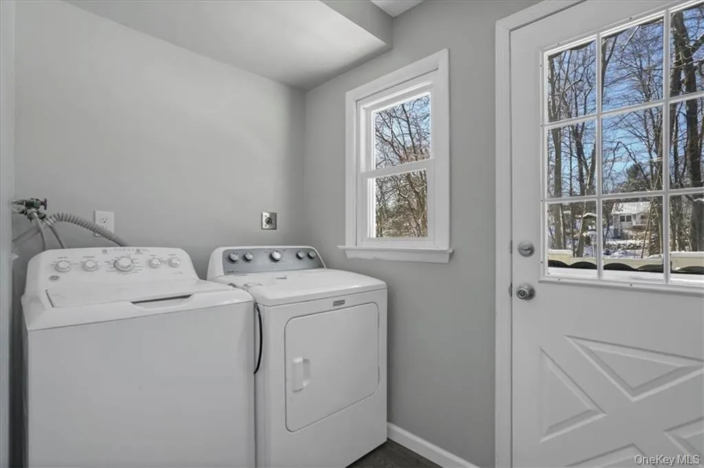 Laundry area featuring baseboards and separate washer and dryer Laundry area featuring baseboards and separate washer and dryer