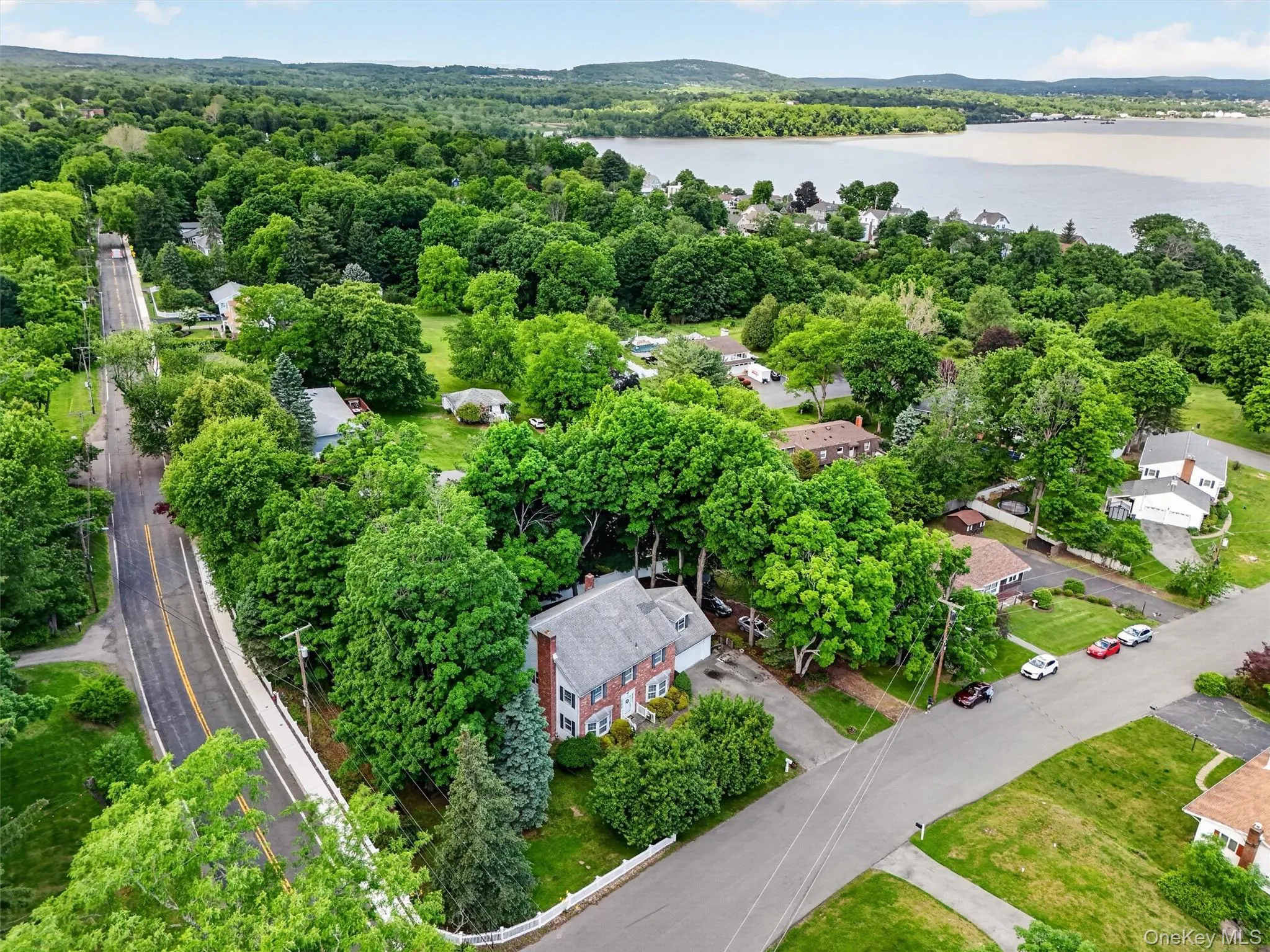 1 Taft in the foreground with the Hudson river in the distance. Property is situated on a corner lot with mature trees and a white picket fence 1 Taft in the foreground with the Hudson river in the distance. Property is situated on a corner lot with mature trees and a white picket fence