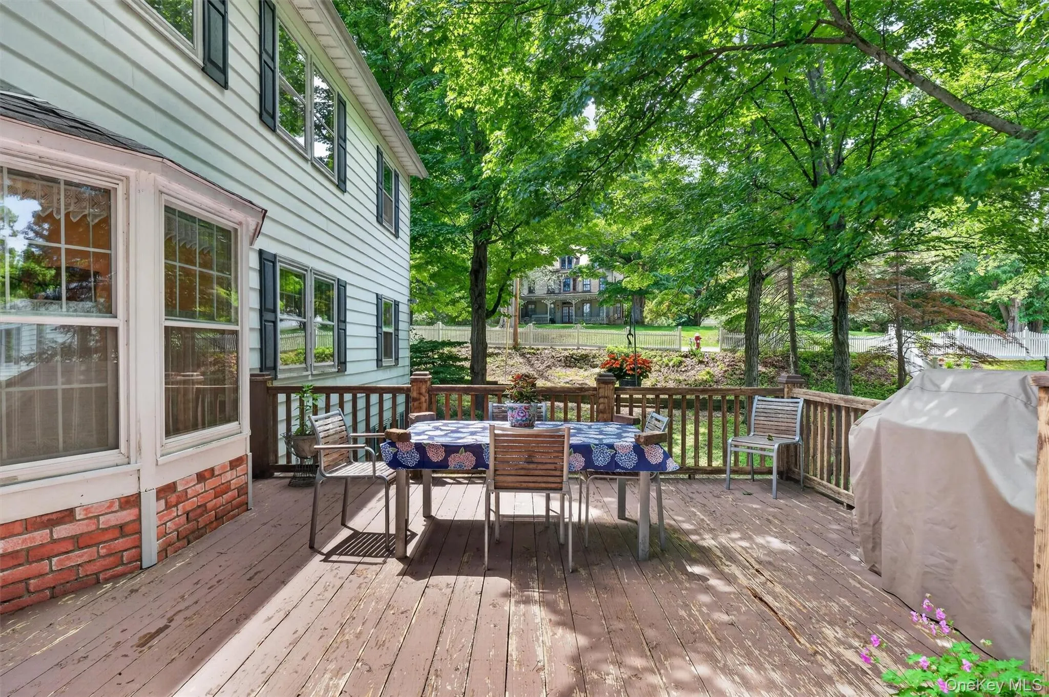 Expansive outdoor deck featuring wood flooring and a perimeter railing Expansive outdoor deck featuring wood flooring and a perimeter railing