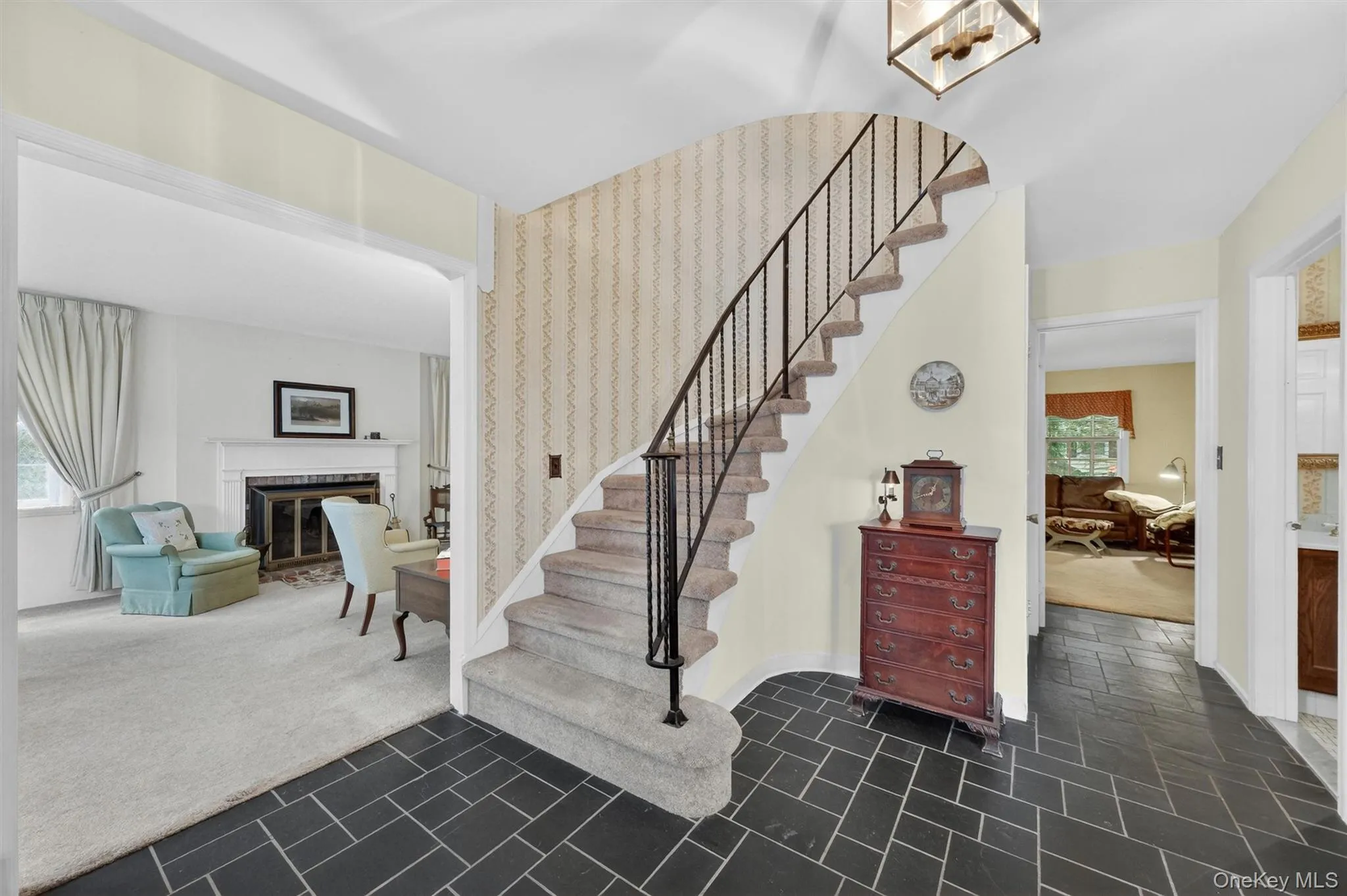 Elegant entry foyer with stone tile flooring an swept stair flows seamlessly to living room, dining room, den and has a powder room 1/2 bath and 2nd level. Elegant entry foyer with stone tile flooring an swept stair flows seamlessly to living room, dining room, den and has a powder room 1/2 bath and 2nd level.