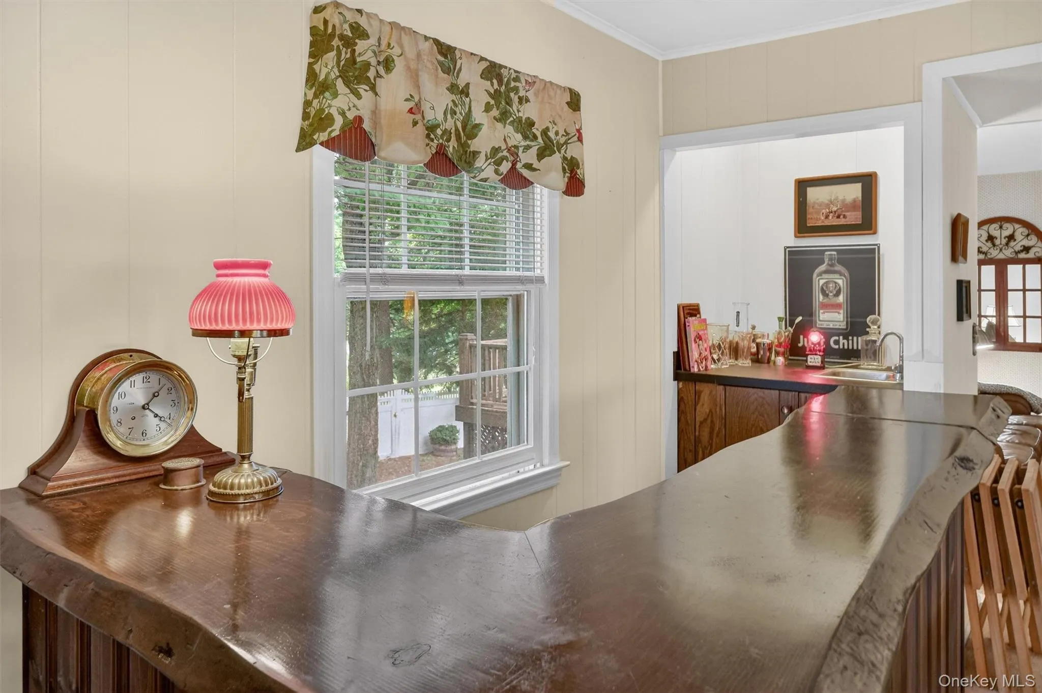 Bar room is just off the living room and adjacent to the family room / den. Wet bar with live edge L shaped bar. Bar room is just off the living room and adjacent to the family room / den. Wet bar with live edge L shaped bar.