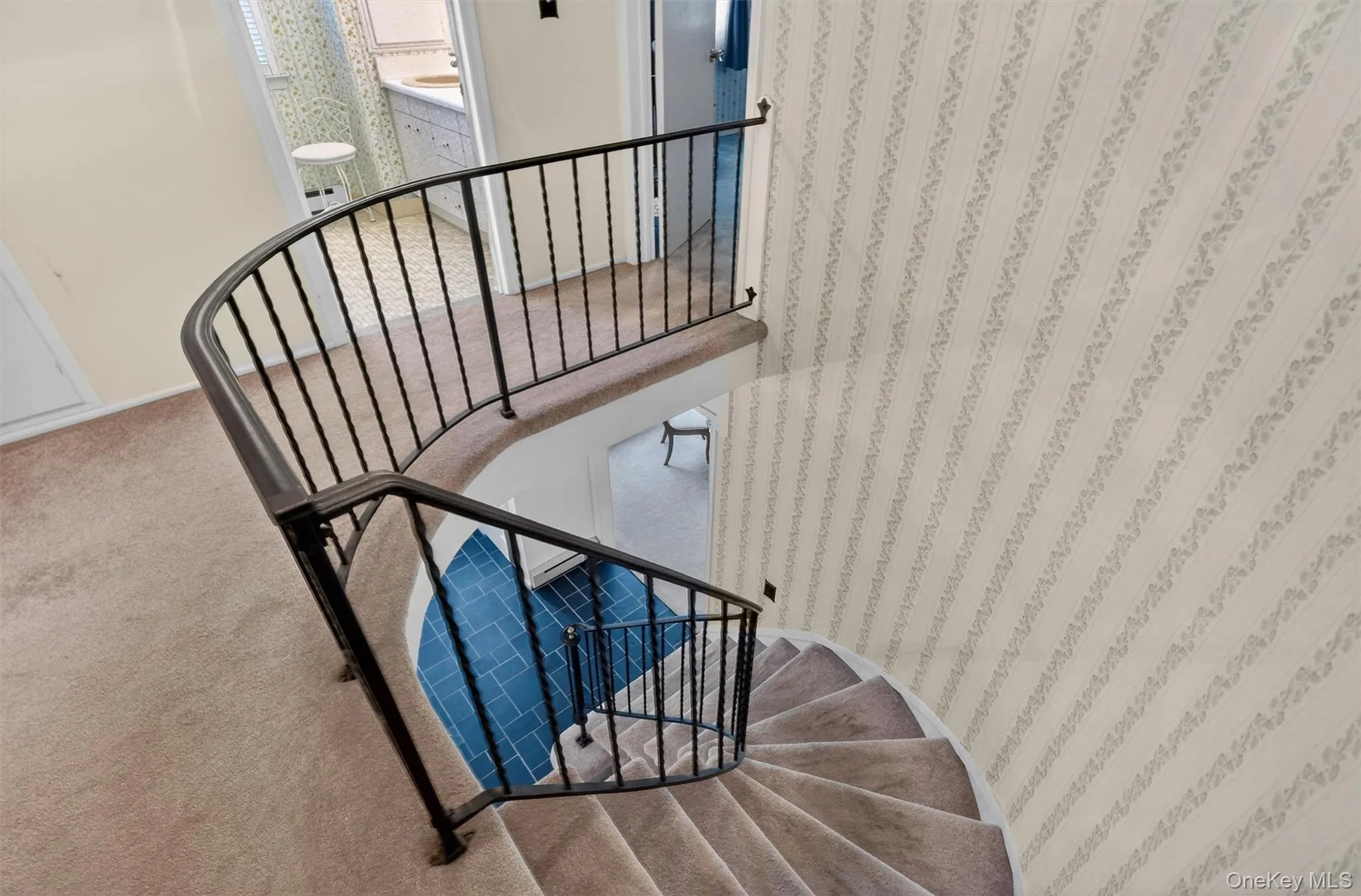 Curved staircase with metal balusters and carpeted treads Curved staircase with metal balusters and carpeted treads
