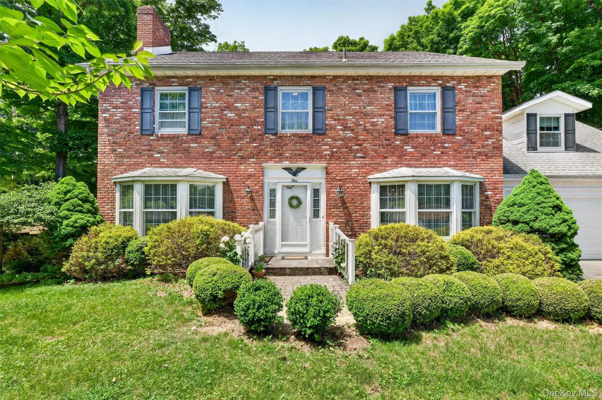 1 Taft offers a classic colonial design. Brick exterior featuring a white entry door with side lights and a transom. 1 Taft offers a classic colonial design. Brick exterior featuring a white entry door with side lights and a transom.