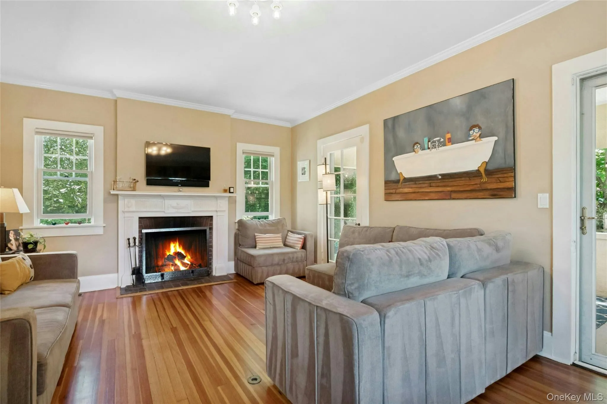 Living room with wood burning fireplace, doors to the covered side porch and built in shelving. Living room with wood burning fireplace, doors to the covered side porch and built in shelving.