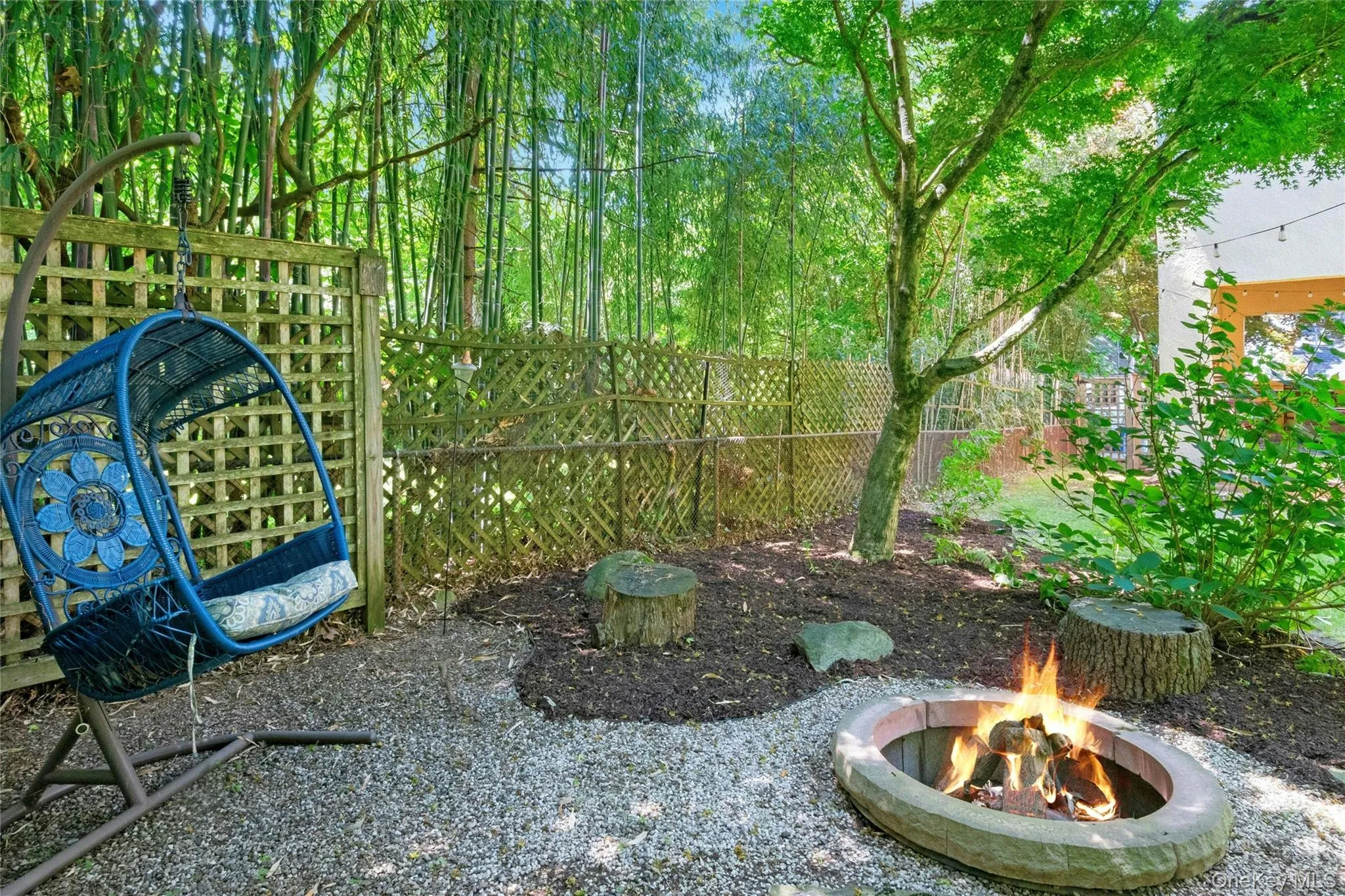 Enjoy a shaded corner in the rear yard with a firepit for those cool evenings. Enjoy a shaded corner in the rear yard with a firepit for those cool evenings.