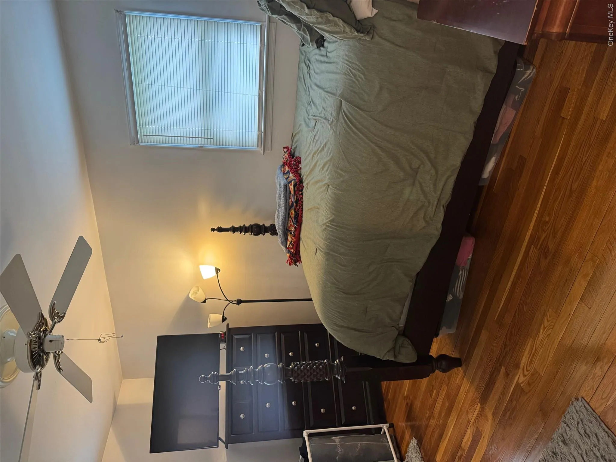 Bedroom with wood finished floors and a ceiling fan Bedroom with wood finished floors and a ceiling fan