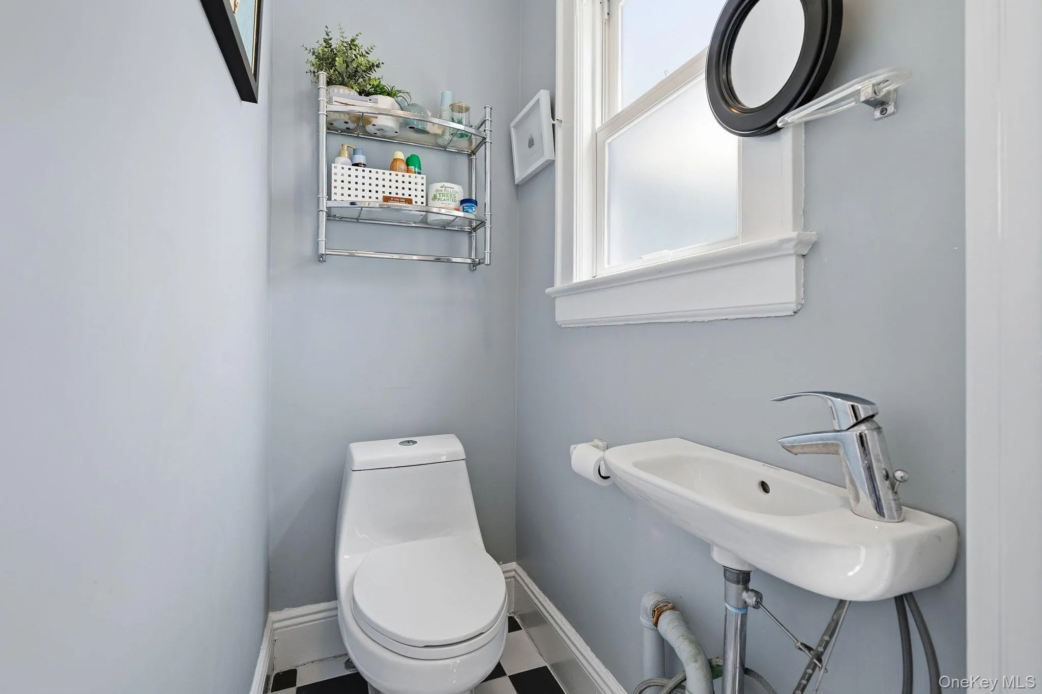 Conveniently located off the kitchen, the stylish powder room offers comfort and ease for guests. Conveniently located off the kitchen, the stylish powder room offers comfort and ease for guests.