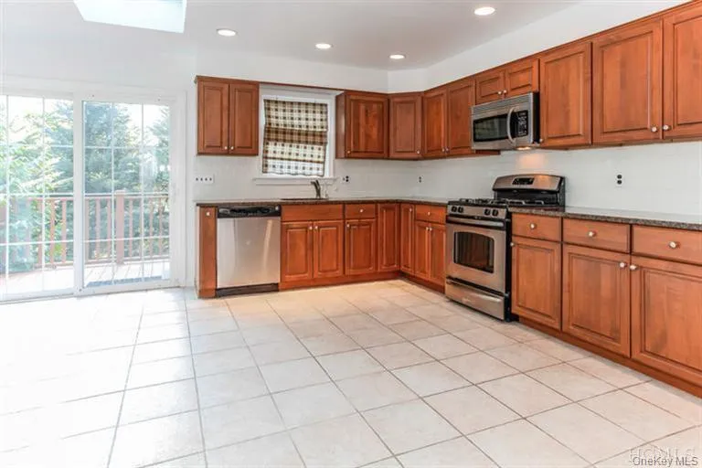 Modern eat in kitchen with new Granite countertops, stainless steel appliances and SGD to rear property Modern eat in kitchen with new Granite countertops, stainless steel appliances and SGD to rear property